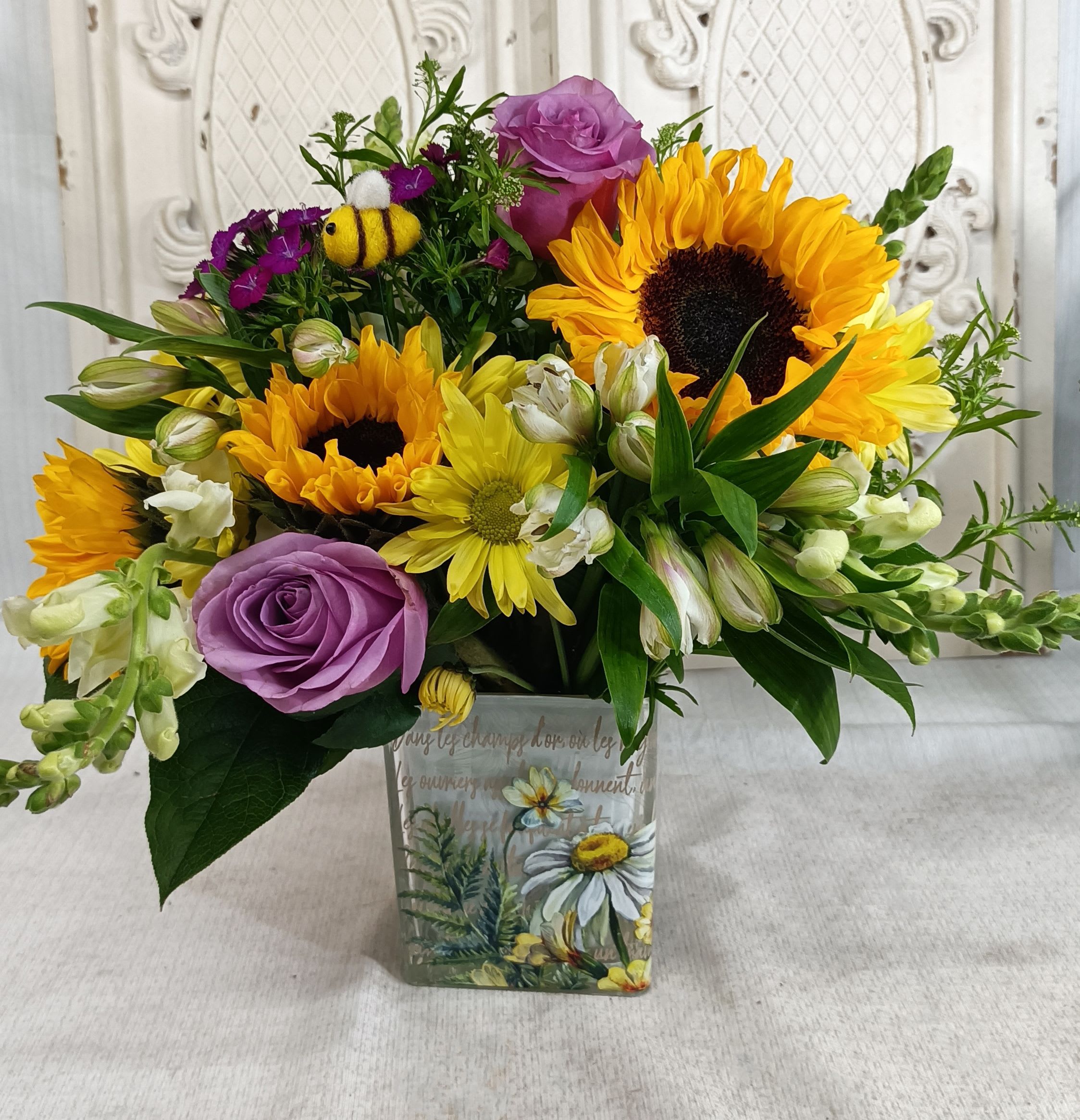 Bee Kind Bouquet - Note: we are currently out of this vase, we witll substitute with yellow. Sunflowers and Roses with a mix of fresh flowers and greenery.