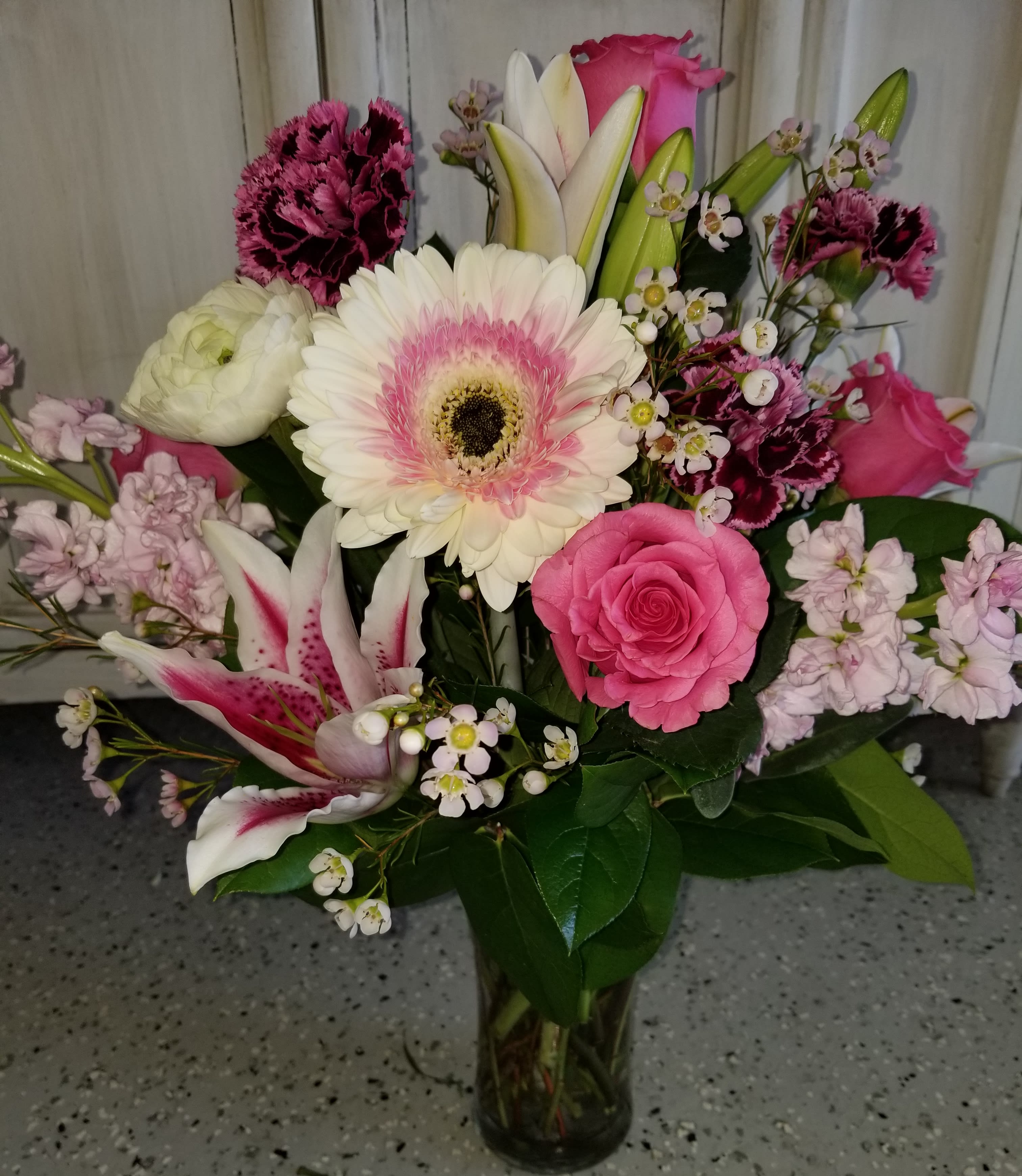Glorious Gerberas - This classic beauty showcases white gerbera daisies with pink edges, alongside pale pink stock, stargazer lilies and antique carnations.