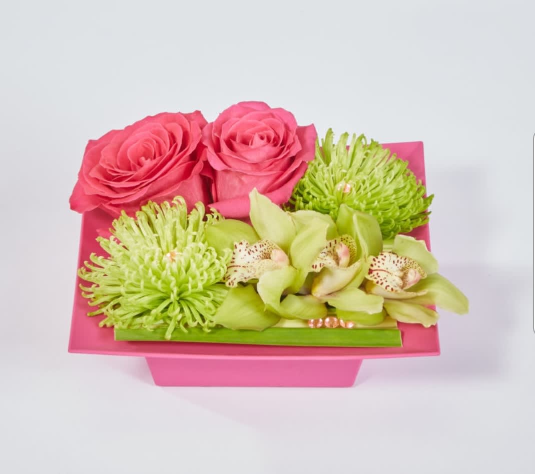 Sassy Cymbids - A beautiful display of roses,  cymbidium blooms and spider mums in a fun pink container 