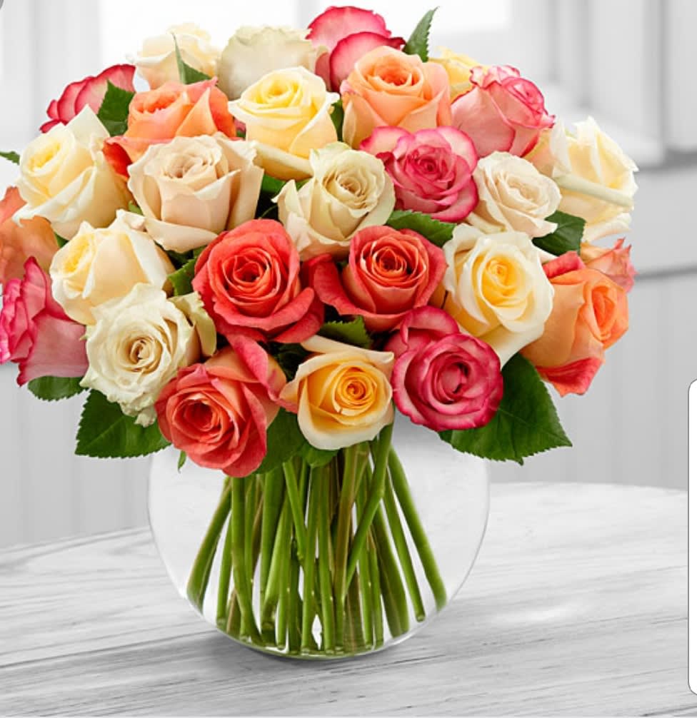 Incandescence - These radiant colored, two dozen roses are arranged beautifully in a bubble bowl vase.