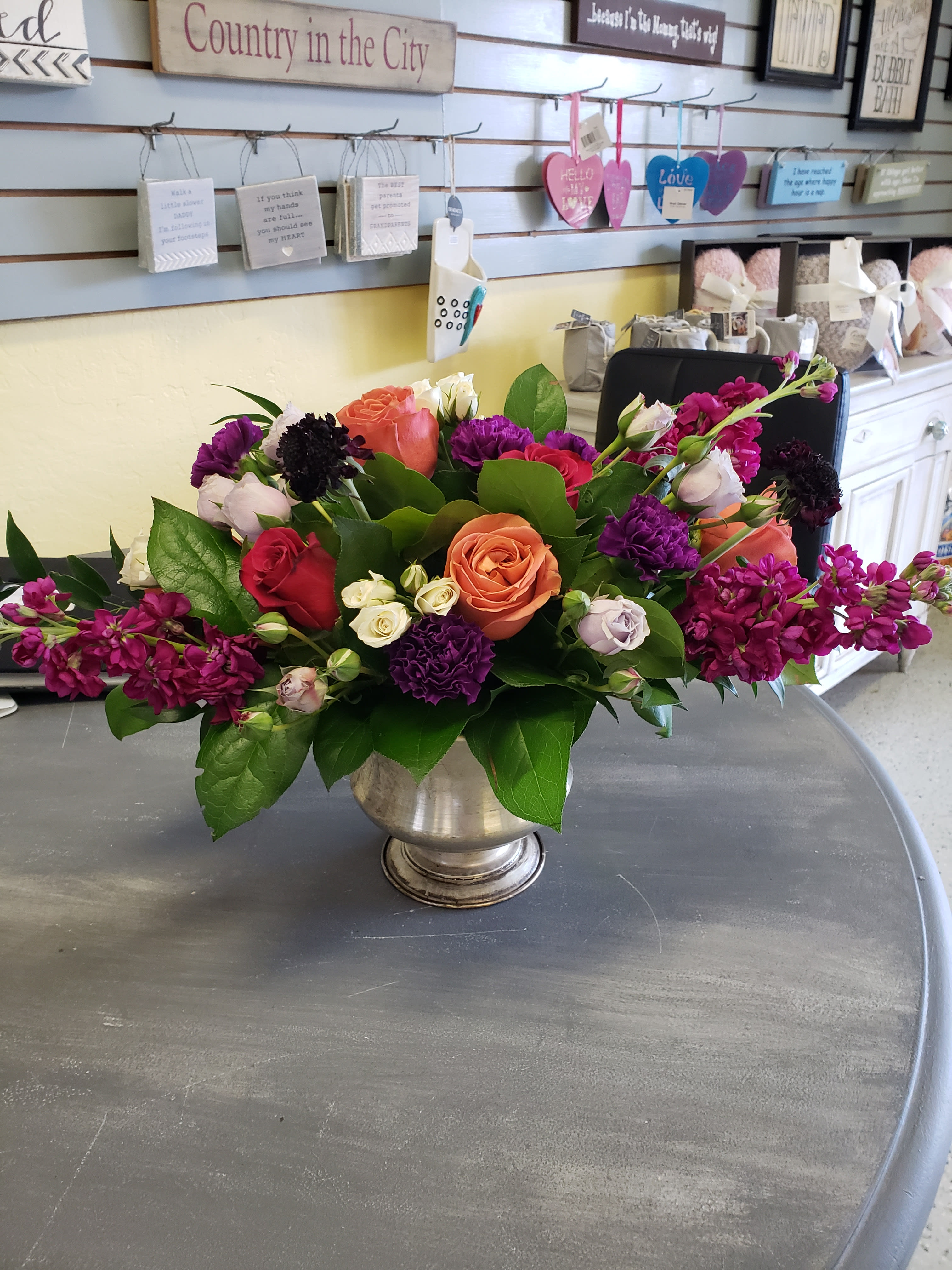 Dark Temptation - This arrangement is full of sass and variety with lots of darker tones, and character, arranged in a pedestal container.