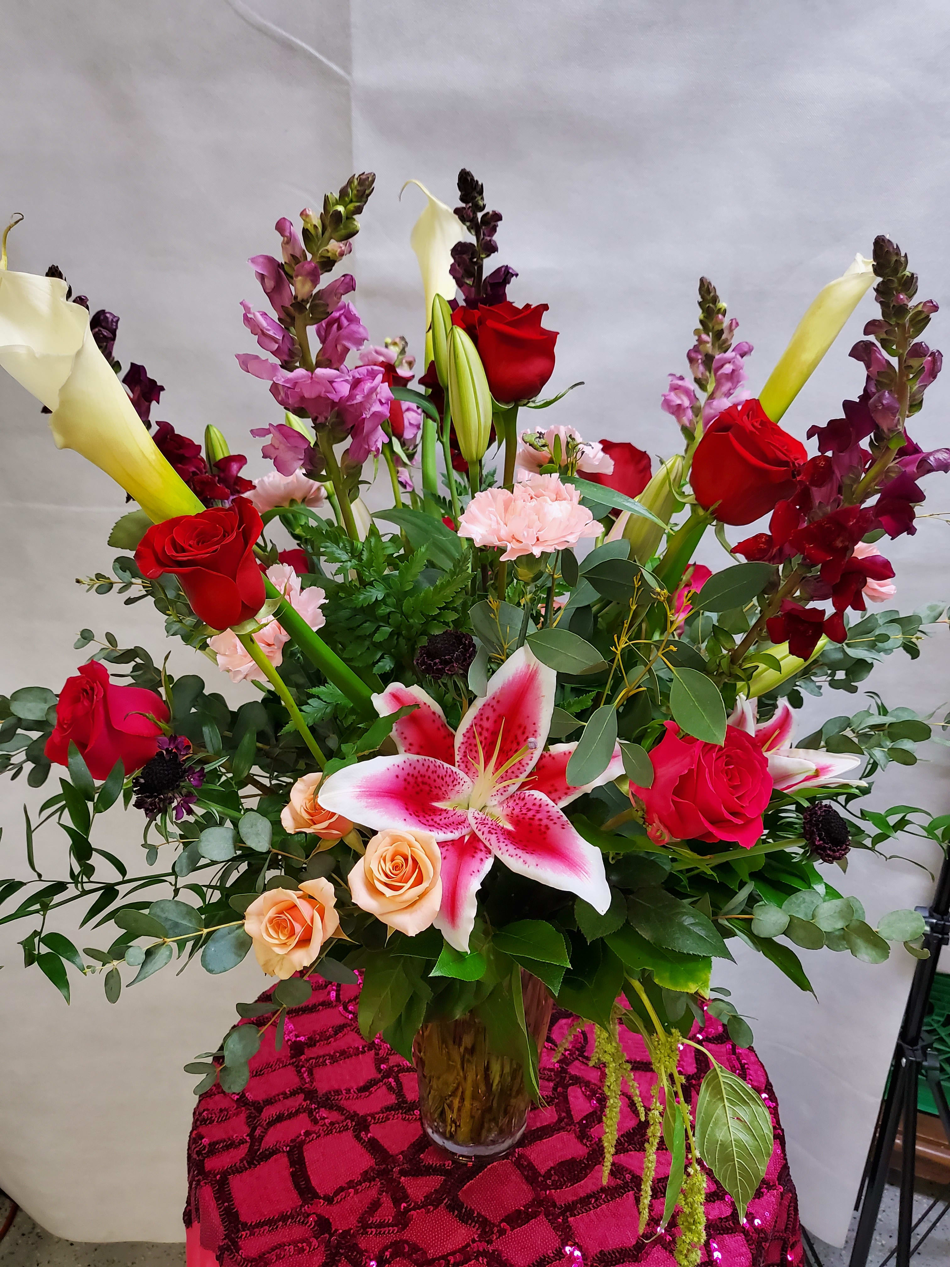 Multi-color madness - Gorgeous multi color arrangement set to fit any occasion big or small! Roses, Lilies &amp; Calla lilies. Premium version shown.