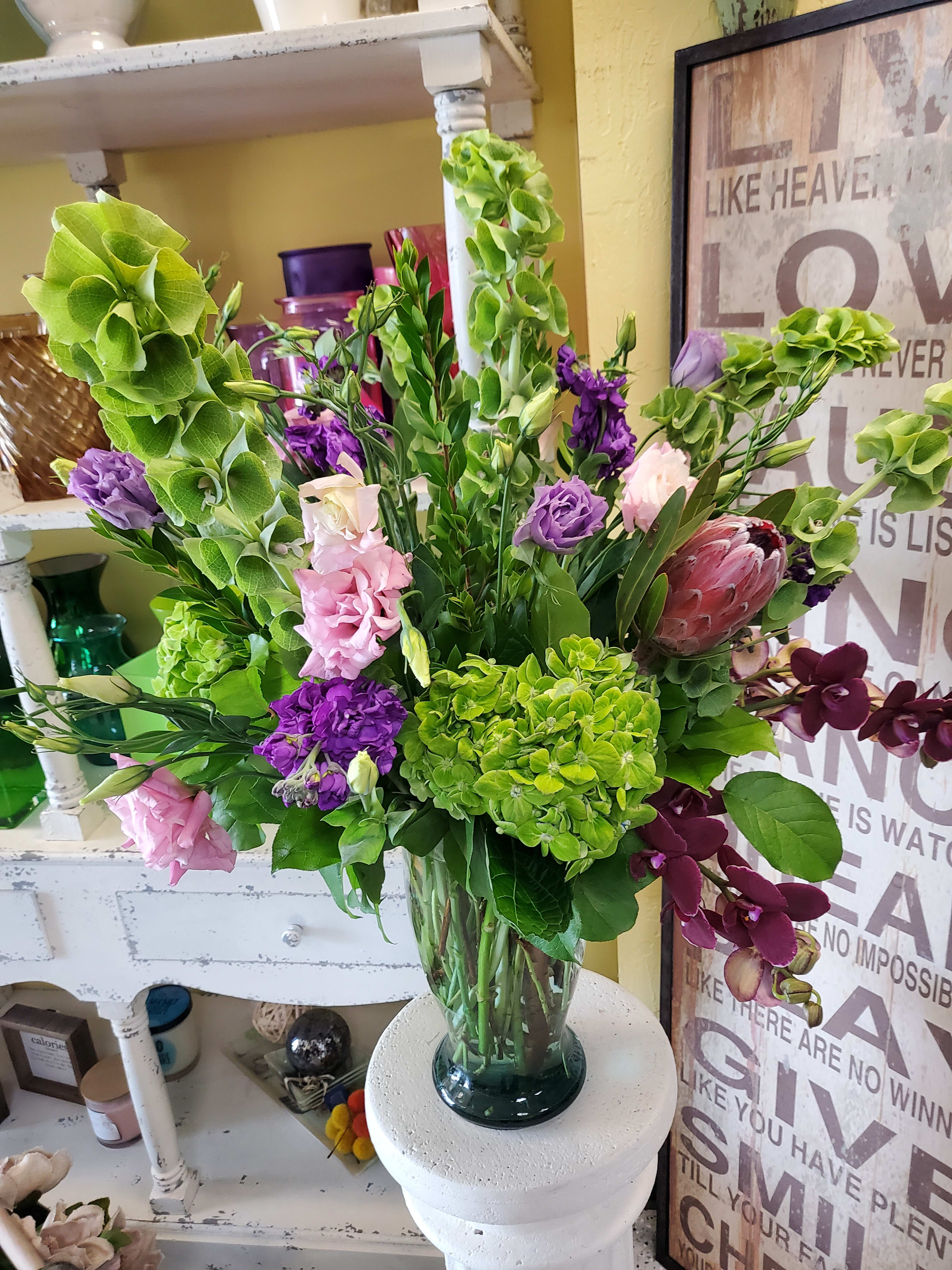 Tropical Arrangement - Full assortment of orchids, hydrangeas and proteas to set the mood for a tropical getaway!