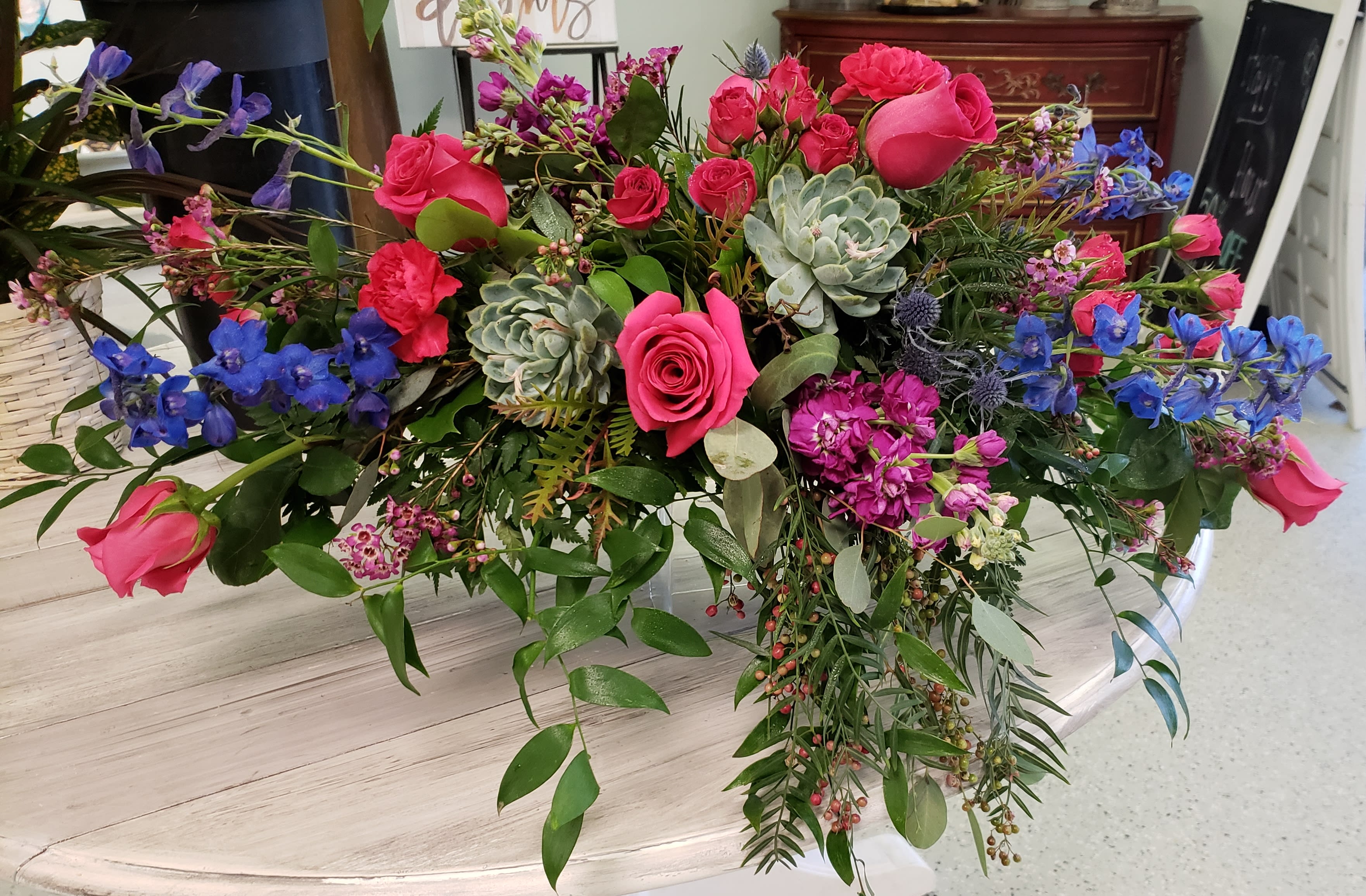 Vibrant Head Table Piece  - This stunning head table piece can be customized to fit any wedding colors and styles. Highlighting succulents, blue delphinium and pops of fuchsia, this is sure to make any wedding special.  *Sizes can be customized.