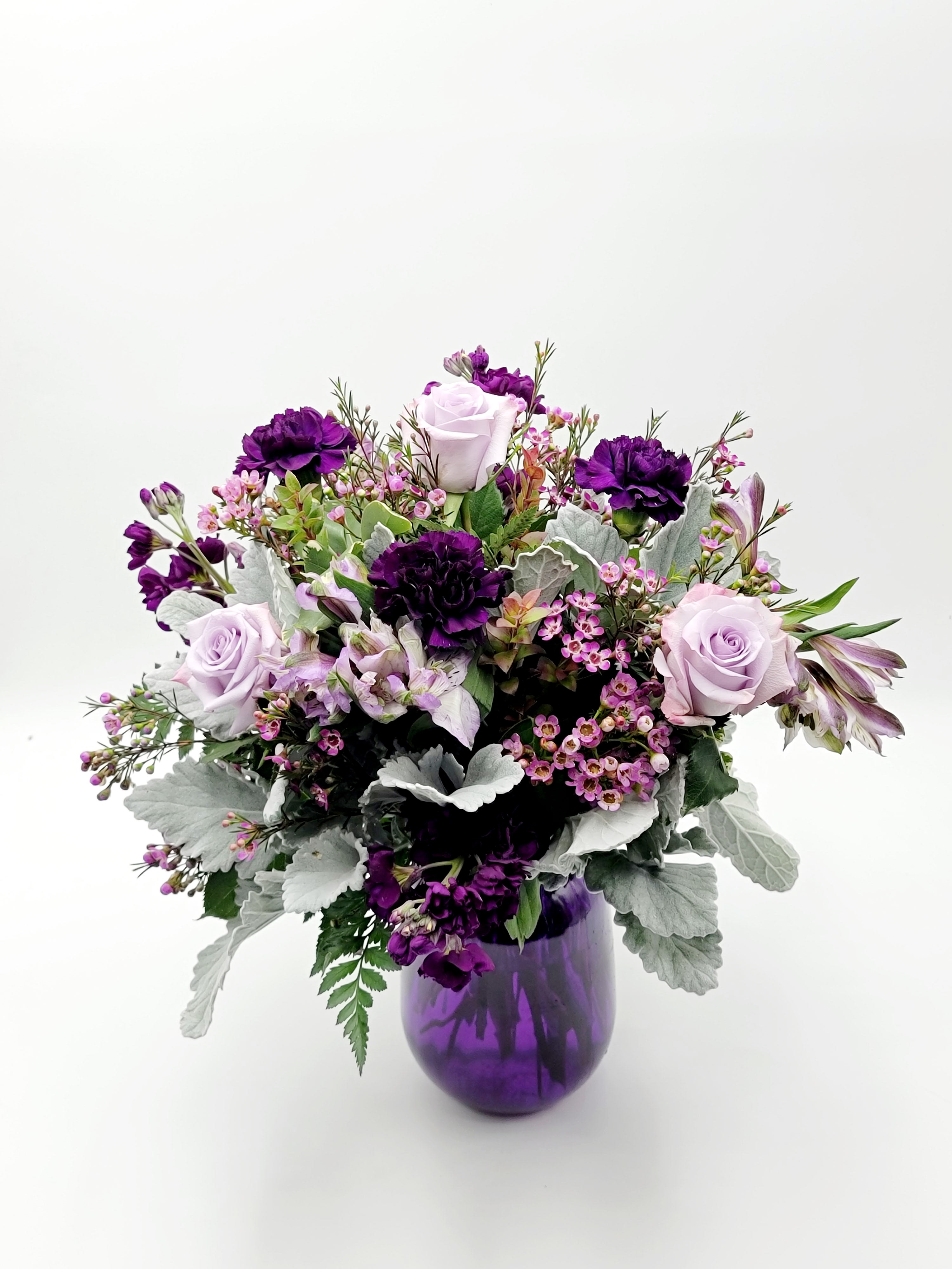 Sassenach - Select this jewel toned, Outlander inspired arrangement that includes stock, carnations and roses.  Roughly 18" tall and 18" in diameter. 