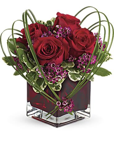 Sweet Thoughts Bouquet  - You love the Sweet Thoughts bouquet, and you'd like to make a big impression. Send thE premium version, and they'll know they've got your heart! With more roses - but the same classic, collectible cube vase in a shade of warmest crimson - this gift will be a surefire hit. A deluxe mix of red roses and Filler - accented with bear grass and greenery - is delivered in a red glass Cube vase.