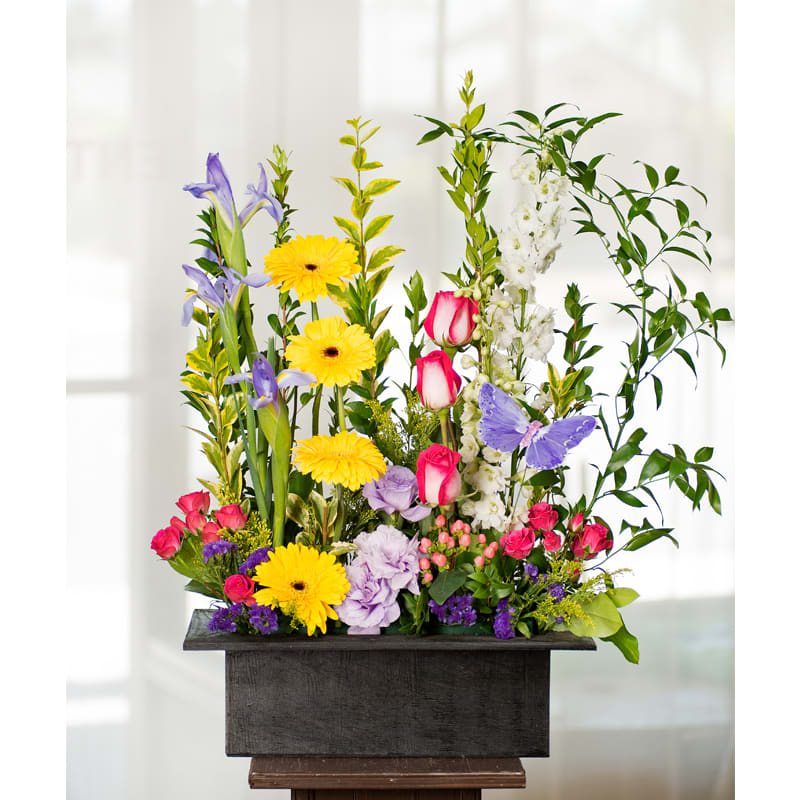Vibrant Springtime Garden***** - Item Code: 121-VF   approx. 24"h x 16"w   The Vibrant Springtime Garden bouquet is designed a rectangular wood container.  This design is made up of a vibrant collection of spring flowers such as roses, larkspur, gerbera daisies, irises, hypericum berries, mini-roses, lisianthus, and statice filler.   