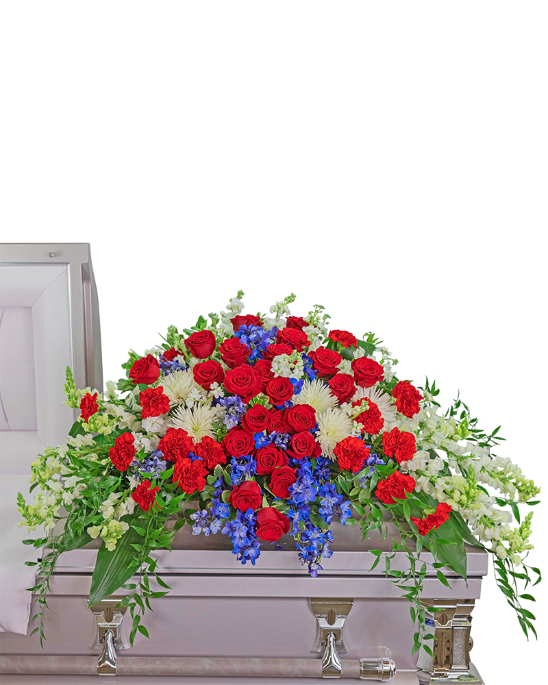 Valiant Honor Casket Spray - This beautiful red, white, and blue casket spray honors the valiant effort of the ones who served our country It is filled with red roses and carnations, blue delphinium, and white snapdragons surrounded by a variety of premium foliage. The Casket Spray is typically provided by the spouse or the immediate family as a heartfelt memorial and is designed to drape over the lid of the casket for a funeral or memorial. Product ID: FCS-126