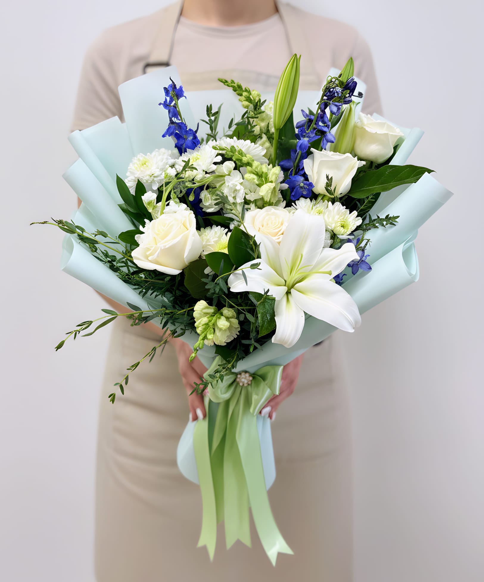 The Prestige Bouquet - A beautifully wrapped bouquet featuring a stunning mix of fresh roses and seasonal flowers, thoughtfully arranged with lush greenery. Hand-wrapped in elegant floral paper, this bouquet offers a modern and stylish presentation perfect for any occasion. A charming and eye-catching design that delivers beauty, freshness, and a touch of elegance.