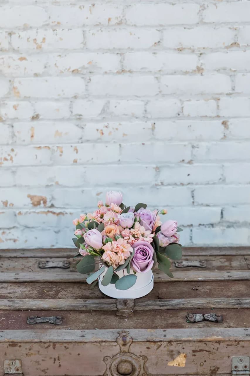 Hamilton Botanical Garden - Bring the beautiful, international gardens to your loved one this season. Take a stroll in the Hamilton Botanical Garden through the full pastel peach and lavender florals, all compactly designed in one of our hand-picked designer hat boxes.  Pictured is [STANDARD]. 