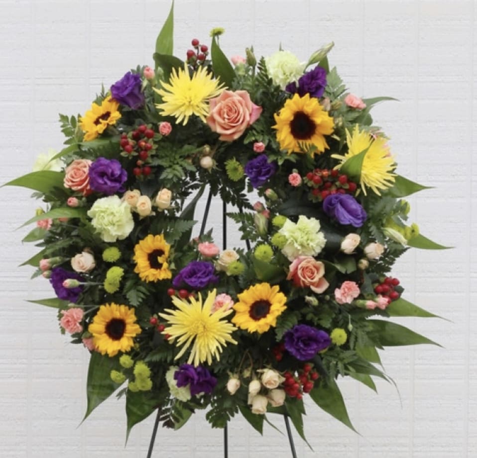  Traditional Sunflower Funeral Wreath - Local Same Day &amp; Express Flower Delivery Funeral wreath designed with Sunflowers, Fugi Mums, Carnations, Lilssianthus and Roses for a colorful memorial.  Designed on a 14 inch wreath form and delivered on an easel. 