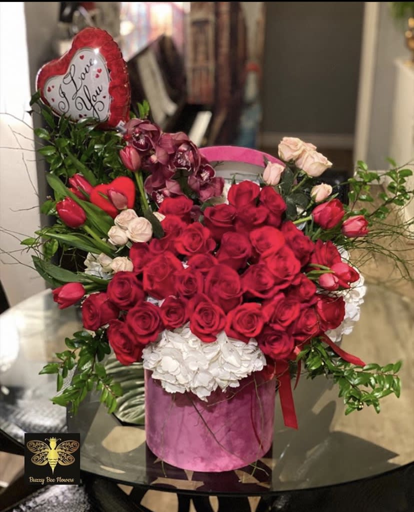 My Sweet Valentine - Buzzy Bee Flowers - This beautiful arrangement is designed to deliver happiness to a loved ones day. Filled with beautiful flowers and customized to perfection, this arrangement is a showstopper! If you want to turn heads then this is the arrangement for you! This is for that special someone!