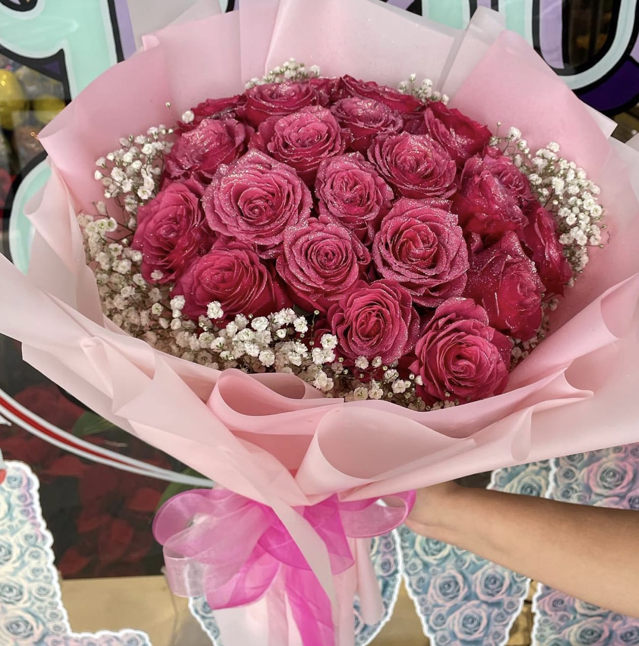 Pink Pony Hand Bouquet - Behold the epitome of fun, cheeky, and all that glitters -  The Pink Pony Hand Bouquet.  STANDARD ROSES LIMITED STOCK / COLOR MAY BE SUBSTITUTED PLEASE CALL FOR STOCK UPDATE