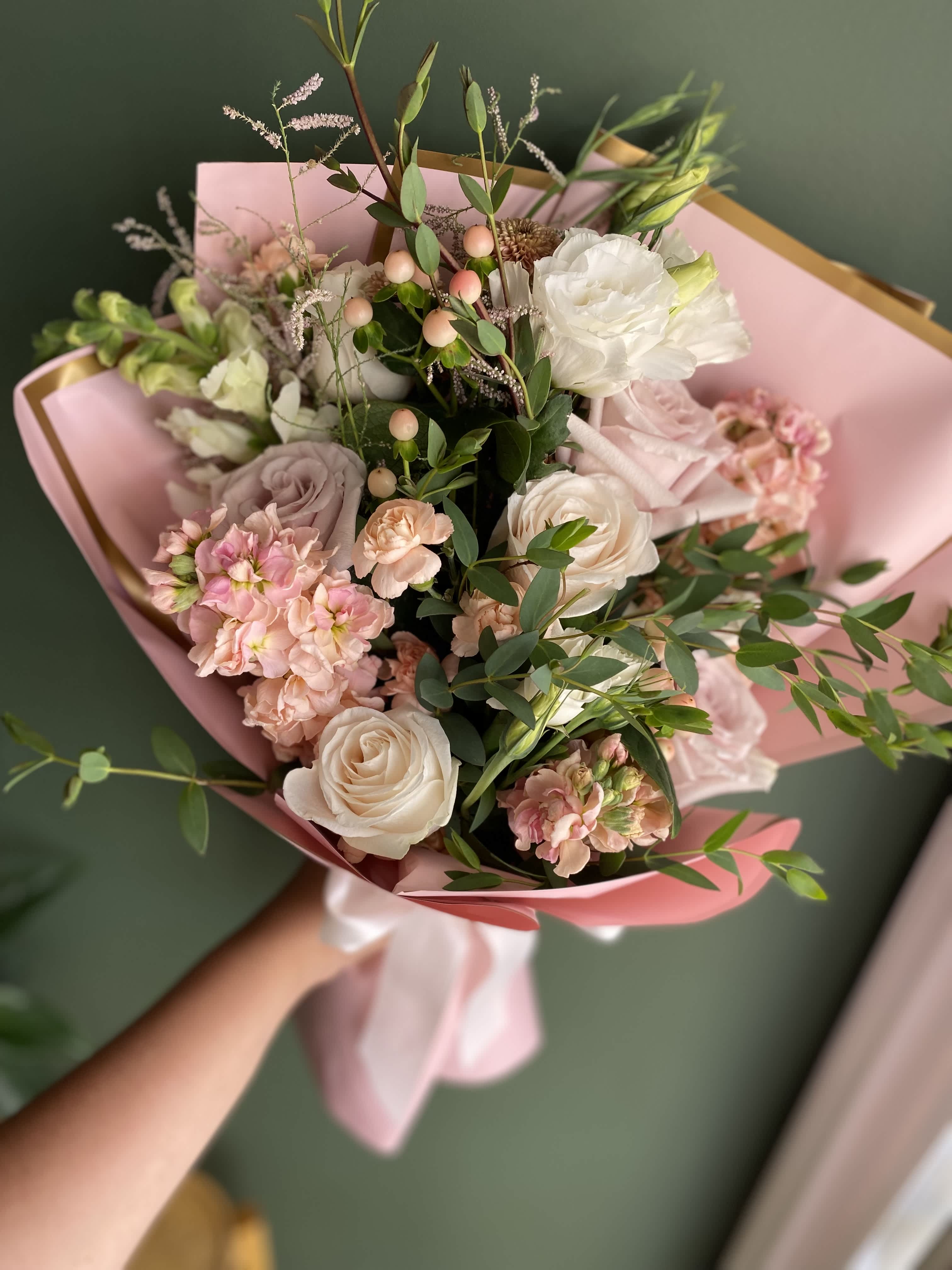 Beauty - A hand wrapped bouquet of soft color blooms and white florals, with silk pink paper