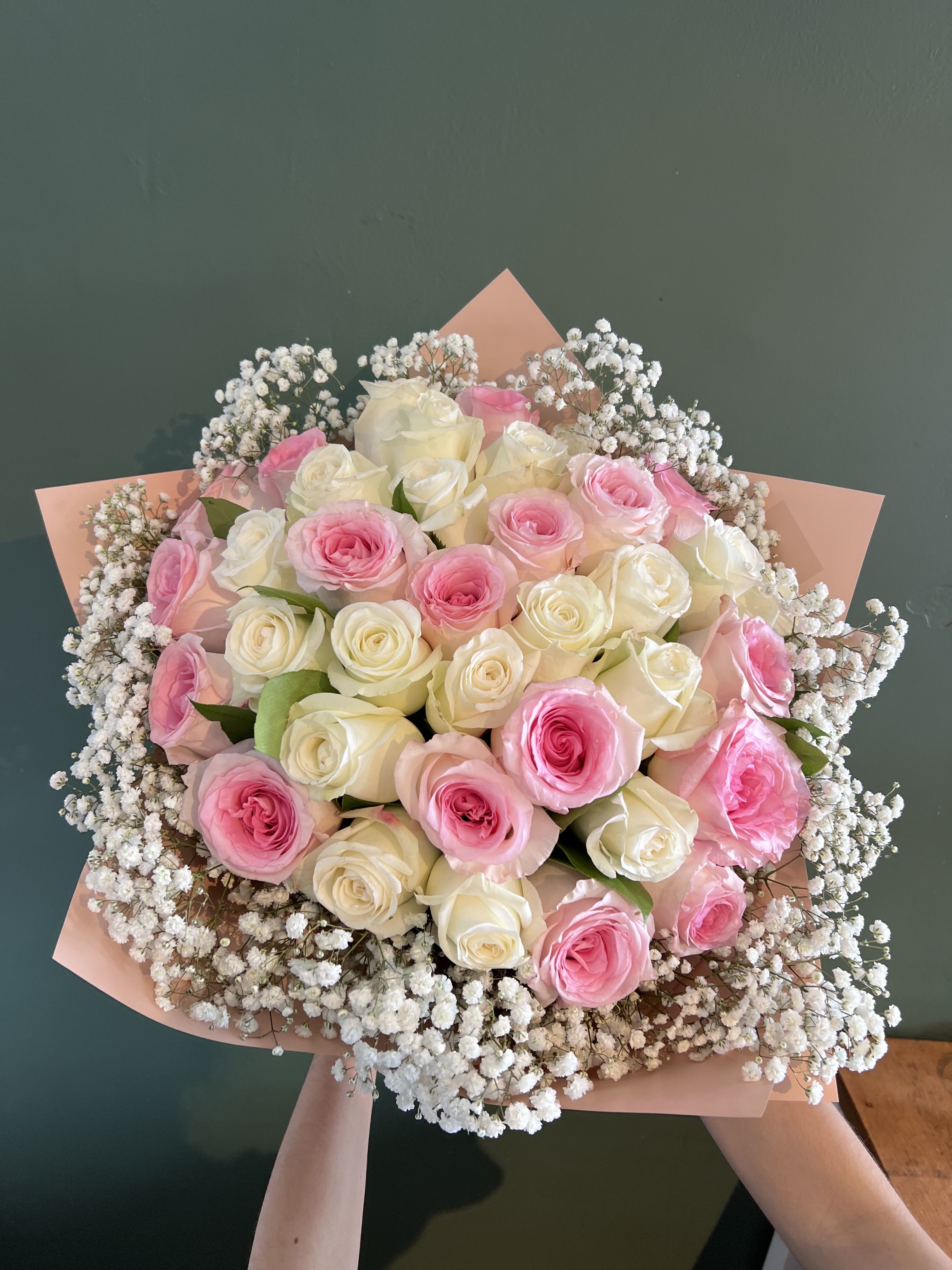 Leezett   - 3 dozens of mix soft pink and white roses, with baby’s breath. Hand wrapped in pink silk paper. 