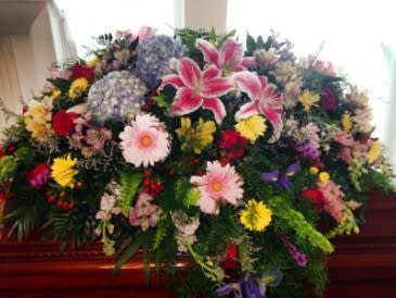 Large mixed floral spray with lilies, daisies, and roses