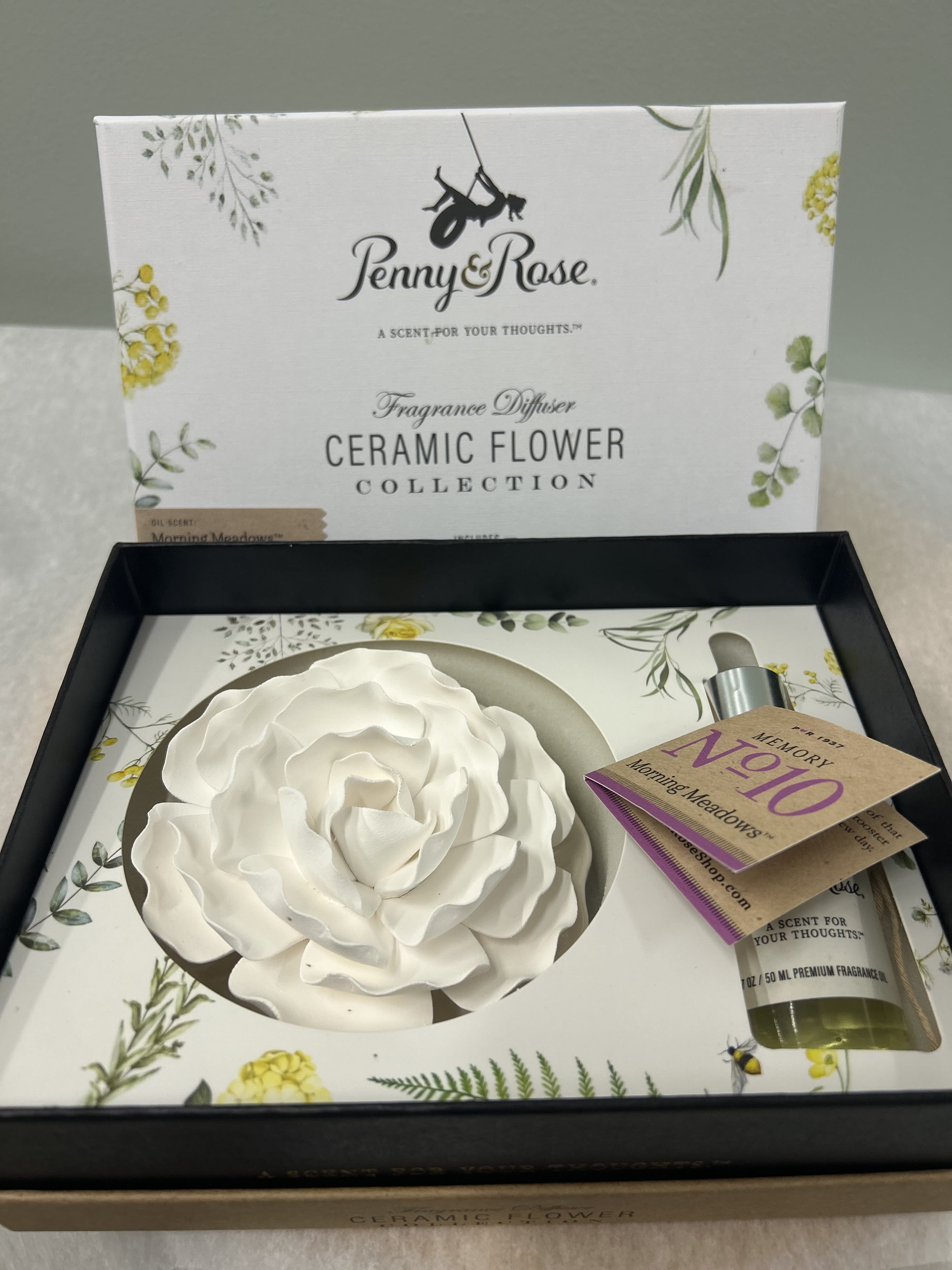 Ceramic Flower Diffuser - Fragrance diffuser collection by Penny &amp; Rose.  Morning Meadows scent.  Fragrance notes: Wildflowers &amp; wonderment.  Collection box includes 1.7 oz premium fragrance oil and 1 ceramic flower on decorative plate.