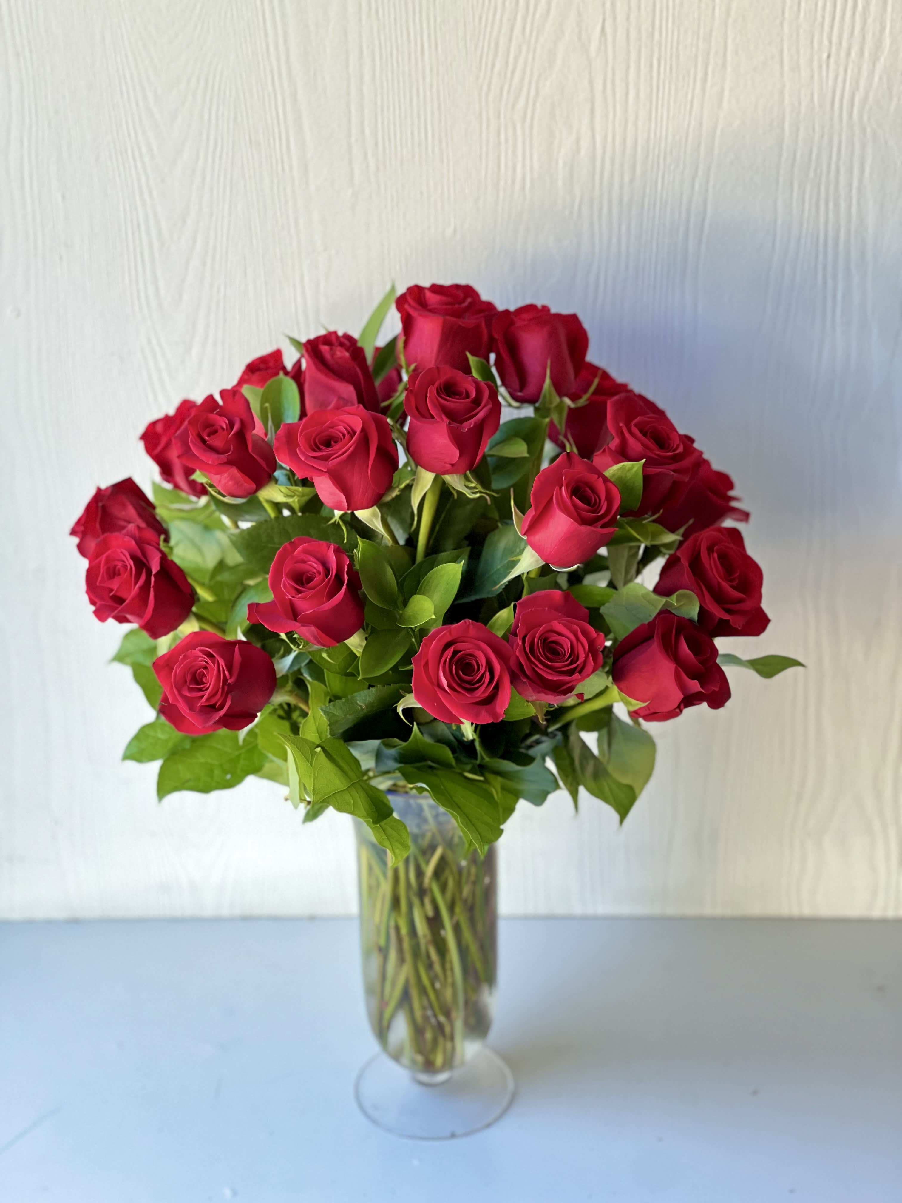  EC114 Classic Long Stem Red Roses -  Dozen Red Roses – Classic Valentine’s Day Flower Delivery in  Tustin, Irivne, Newport Beach &amp; Surrounding Areas Surprise your loved one with the timeless beauty of our 1 Dozen Red Roses bouquet – the ultimate symbol of love and passion. At Everyday Creations, we hand-select each rose for its long stem, rich red color, and lush, velvety petals. Choose our Deluxe version to elevate your gesture with 2 dozen breathtaking red roses in a premium glass vase.  Whether you're celebrating Valentine’s Day, an anniversary, a romantic birthday, or just want to say "I love you," this arrangement makes a lasting impression. Red roses represent deep affection and desire – making this elegant bouquet the perfect gift for someone special.  Why Choose Our Red Roses: Premium long-stem red roses with lush petals,Standard (12 roses) or Deluxe (24 roses) available,Designed in a beautiful vase for a classic, luxurious look  Ideal for Valentine’s Day, anniversaries, or romantic surprises, Same-day flower delivery in  Tustin,Irivne , Newport Beach, Costa Mesa, and surrounding Orange County areas,Order now from Everyday Creations, your trusted local florist in Irvine, CA, and let us deliver a heartfelt expression of love to your special someone.    