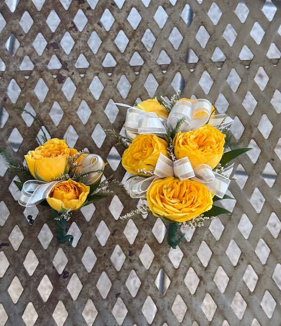 Yellow rose corsage and boutonniere set - Corsage and Boutonniere (examples for customers) We pre-order over Florals with our growers two weeks in advance prior to a school dance. Select your color of ribbon of your choice. Keep in mind, these are examples from past years, we are not guarantee types of roses from our growers. Corsage- $38.00 Boutonniere- $21.00 -Any add-ons such as delphinium, rhinestone, double ribbon or magnetic boutonnieres are subject to an addition fee