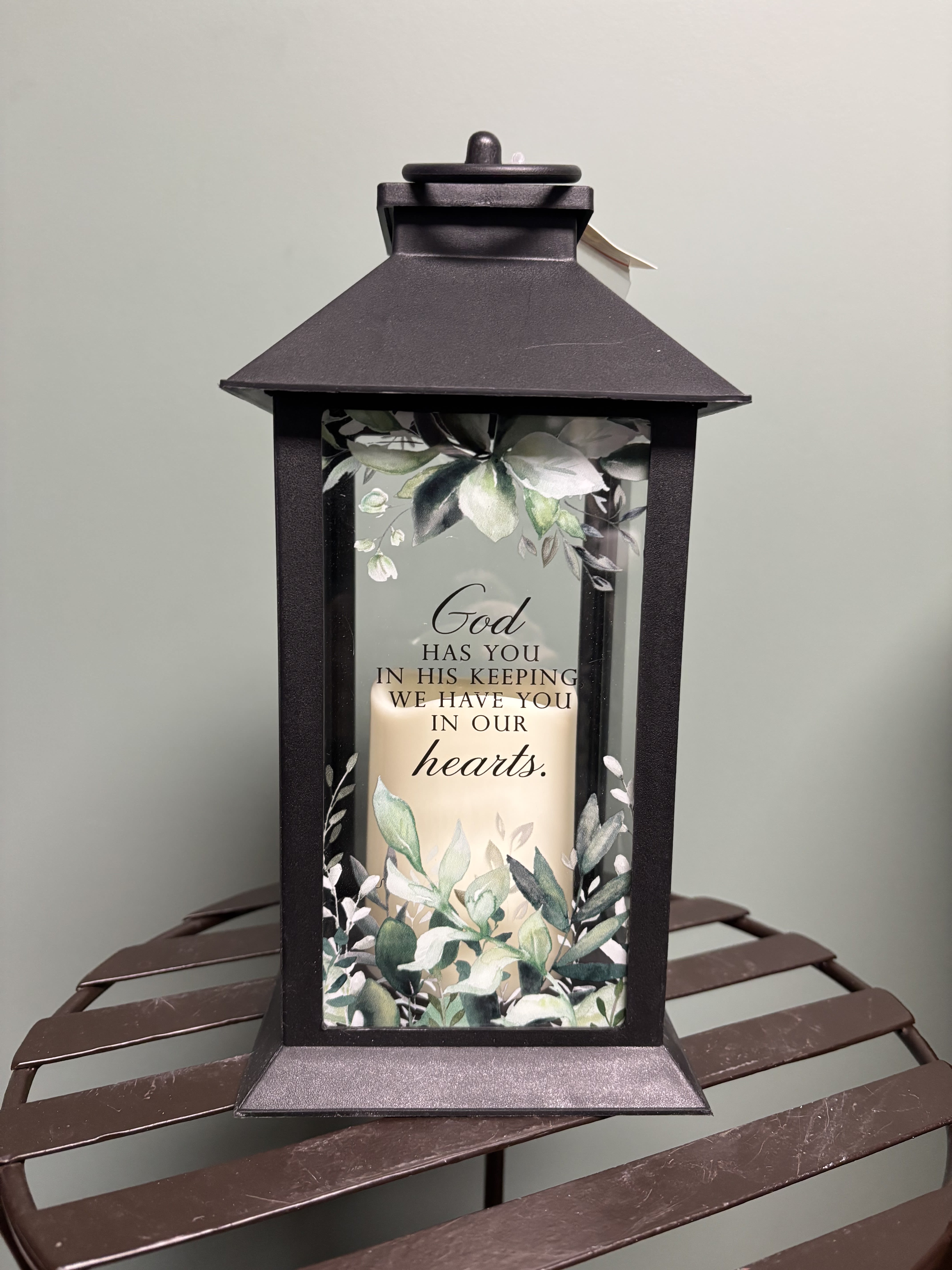 Black memorial lantern with a candle and floral print