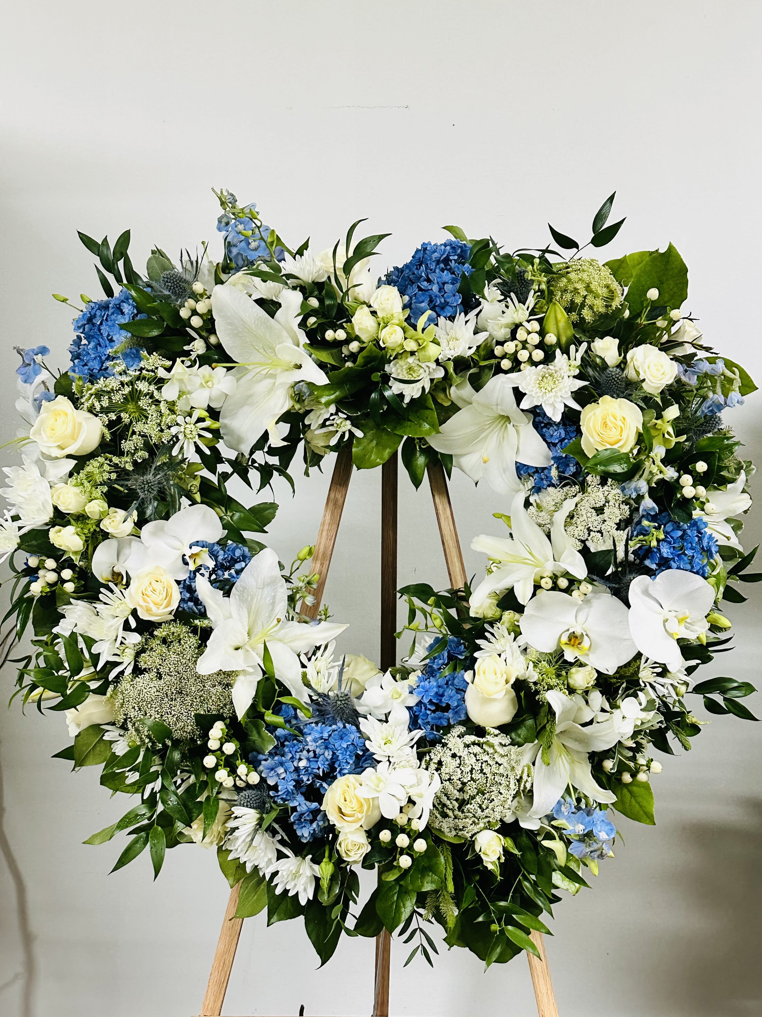 Blue and White Heart Easle - Heart shaped wreath, whites and light blues show a touching display of devotion. ( Picture shown is Premium)