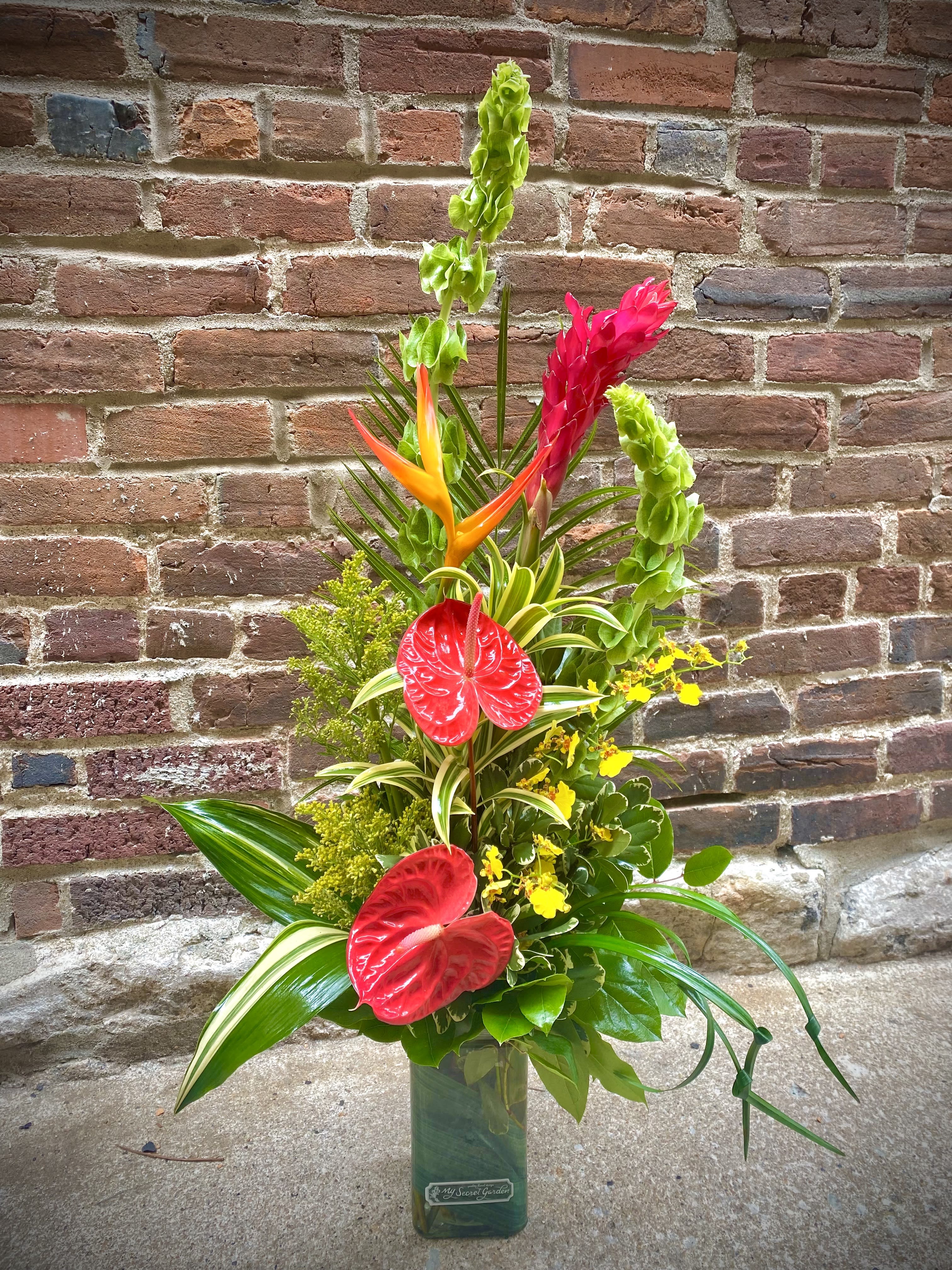 Tropical Pizzazz - Unique and full of fun, the Tropical Pizzazz design is sure to impress. Includes Antherium, Ginger, Tropic Fleur, Oncidium Orchids and Bells of Ireland in a contemporary design. Perfect for an office space or home