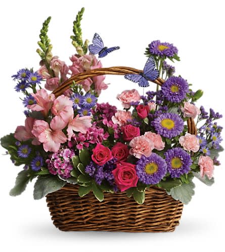 Country Basket Blooms - Talk about a bountiful basket! This wicker basket is overflowing with beauty and blossoms. It's no wonder two pretty butterflies have made this basket their home. Hot pink spray roses light pink alstroemeria snapdragons and miniature carnations dark pink Sweet William purple matsumoto asters large monte cassino asters statice and pittosporum fill a pretty picnic-like basket. You've got this gift handled!Approximately 16 1/2" W x 16 1/2" H Orientation: One-Sided As Shown : T48-3ADeluxe : T48-3BPremium : T48-3C