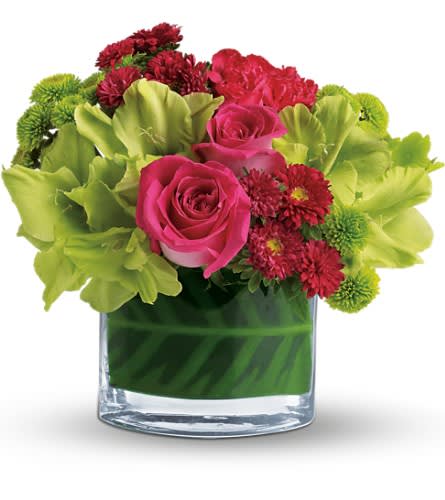 Teleflora's Beauty Secret - We can't keep this beauty a secret any longer. It's just too pretty too fun and way too fabulous! After all beauty secrets like this one are even better when they're shared. Hot pink roses green gladioli hot pink mini carnations red matsumoto asters green button spray chrysanthemums and a calathea leaf are delivered in a distinctive oval vase.Approximately 10" W x 9 3/4" H Orientation: All-Around As Shown : T159-2ADeluxe : T159-2BPremium : T159-2C