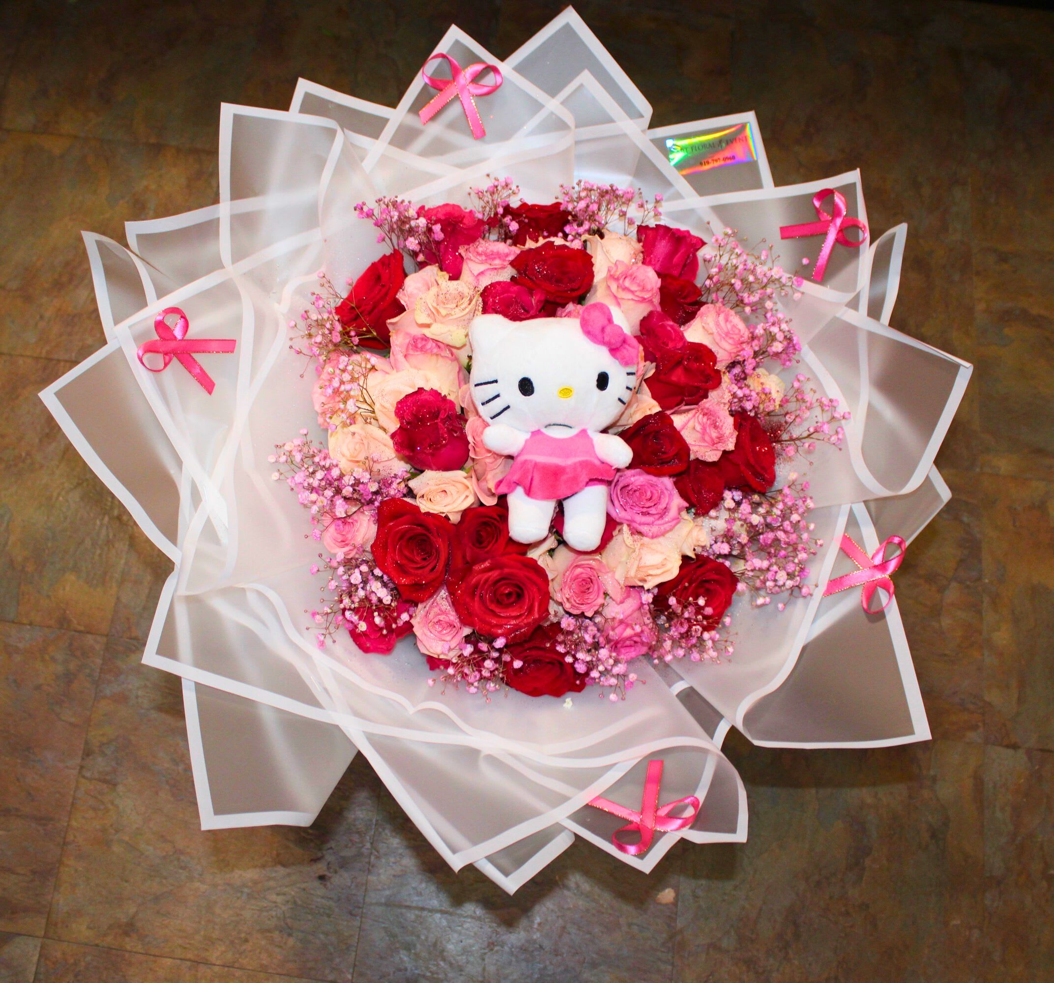 Hello Kitty Bouquet - 50 Red, Pink, and White Roses Pink Accent Bows Hello Kitty Stuffed Teddy.  Wrapped in white lux waterproof paper.   Wrapped Bouquet *NO VASE INCLUDED*.