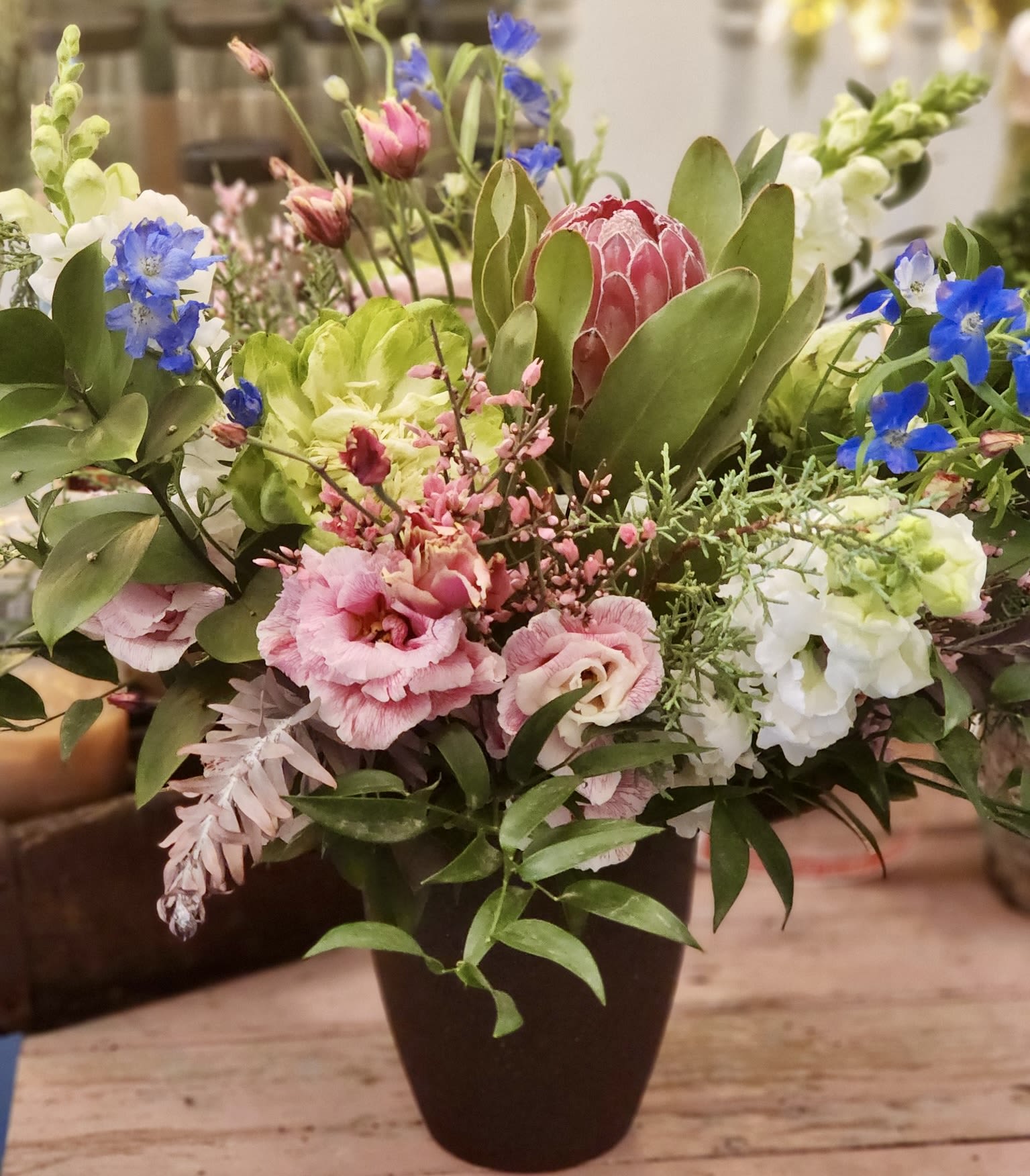 Winter Dream  - Our  Winter Dream centerpiece is such a beautiful mix of romantic colors &amp; whimsical textures. A sure dreamy combination. Flowers will be housed in a glass or clay vase.   Every effort will be made to recreate your chosen design. Please note that from time to time due to product availability and quality we may need to make substitutions. We will make sure to keep the original design in mind when making substitutions. 