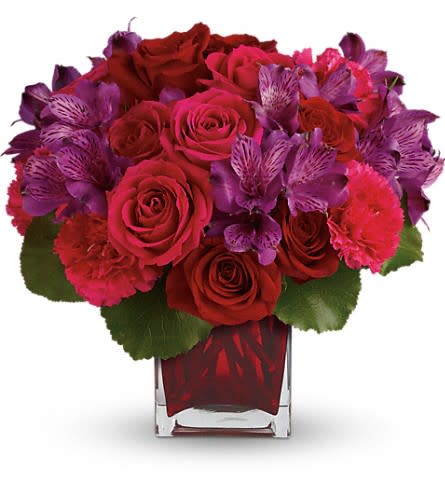 Teleflora's Take My Hand Bouquet - Simply breathtaking! Spoil her any day of the week with this decadent gift of red and pink roses accented with delicate purple alstroemeria and hand-delivered in a gorgeous red glass cube. This lush arrangement features red roses dark pink roses purple alstroemeria hot pink carnations and galax leaves. Delivered in a red cube vase. Approximately 12 1/2" W x 11 1/2" H Orientation: All-Around As Shown : T600-6ADeluxe : T600-6BPremium : T600-6C