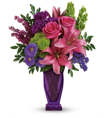 You're A Gem Bouquet by Teleflora - Shine bright! Make their eyes sparkle with this luxe bouquet of roses and lilies in stunning gemstone shades. Exquisitely designed and hand-delivered in an exclusive violet Couture vase it's a grand gift they'll always remember! This bright arrangement is made up of pink roses dark pink asiatic lilies purple carnations lavender matsumoto asters green cushion spray chrysanthemums bells of Ireland pink heather purple sinuata statice huckleberry and lemon leaf. Delivered in a violet Couture vase.Approximately 13 1/2" W x 16" H Orientation: One-Sided As Shown : TEV42-7ADeluxe : TEV42-7BPremium : TEV42-7C