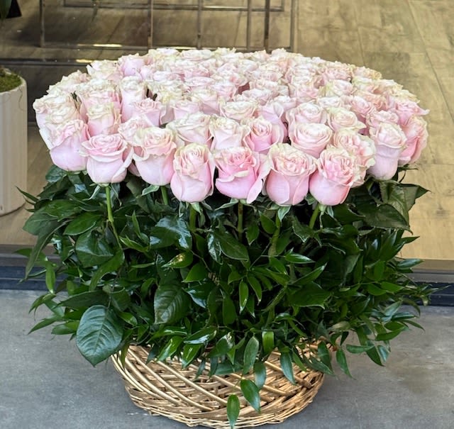 50 Pink Roses in Woven Basket - Premium roses arranged in a woven basket for a full, elegant presentation. Finished with exposed leaves. Delivered fully arranged and ready to impress. Roses in Woven Basket Hand-arranged fresh pink roses in a reusable woven basket.      Available: Deluxe: 100 Roses Premium: 150 Roses   Some florals are seasonal, if a particular flower will not be available due to season, we will substitute for similar flower, composition, color pallet and value of the arrangements as closely as possible. All effort to create a floral arrangement as close to the photo shown, the actual arrangement may vary slightly in its appearance from the photo shown. If you have any questions about your order, we welcome you to call us in or email    Holiday Delivery:  Same-day delivery available. Deliveries are made throughout the day based on routing.  