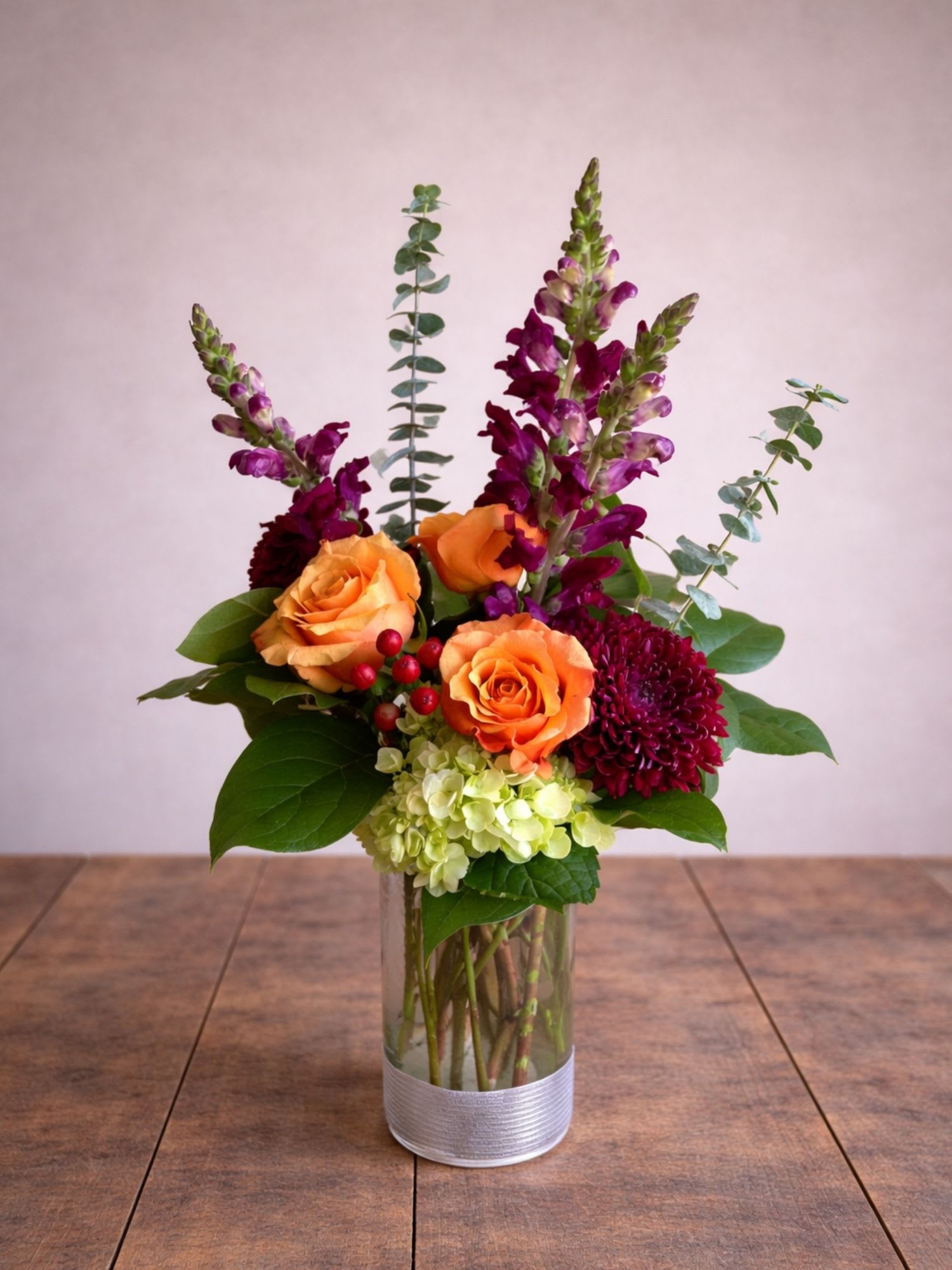 Anjelica's Awesome Blooms  - Anjelica’s Awesome Blooms is a vibrant floral arrangement featuring orange roses, seasonal blooms, and fresh greenery, handcrafted by Floral Fabulous and available for same-day flower delivery in Round Rock, Texas.  This lively arrangement blends rich orange roses with textured seasonal flowers, snapdragons, hydrangea, and lush greenery to create a bold and elegant design. The combination of warm tones and vertical floral accents adds height, movement, and visual interest.  Designed in a modern glass vase, this arrangement makes a striking gift for birthdays, celebrations, thank-you gifts, or simply brightening someone’s day.  Each arrangement is handcrafted by the floral artists at Floral Fabulous and is available for same-day flower delivery in Round Rock and surrounding communities.