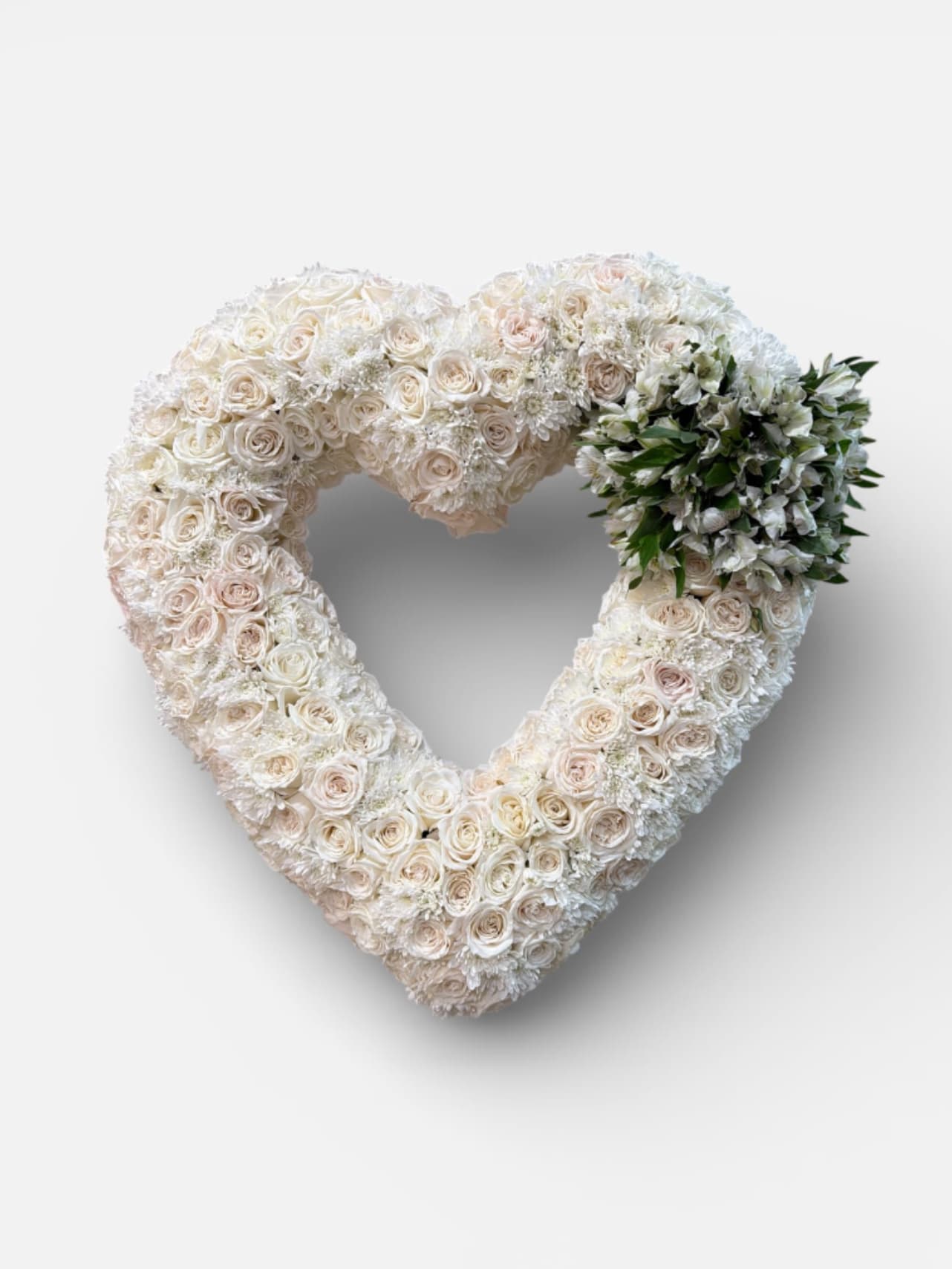 Ivory Remembrance Heart - A delicate heart shaped tribute of ivory roses and white blooms, expressing, love, peace, and remembrance.