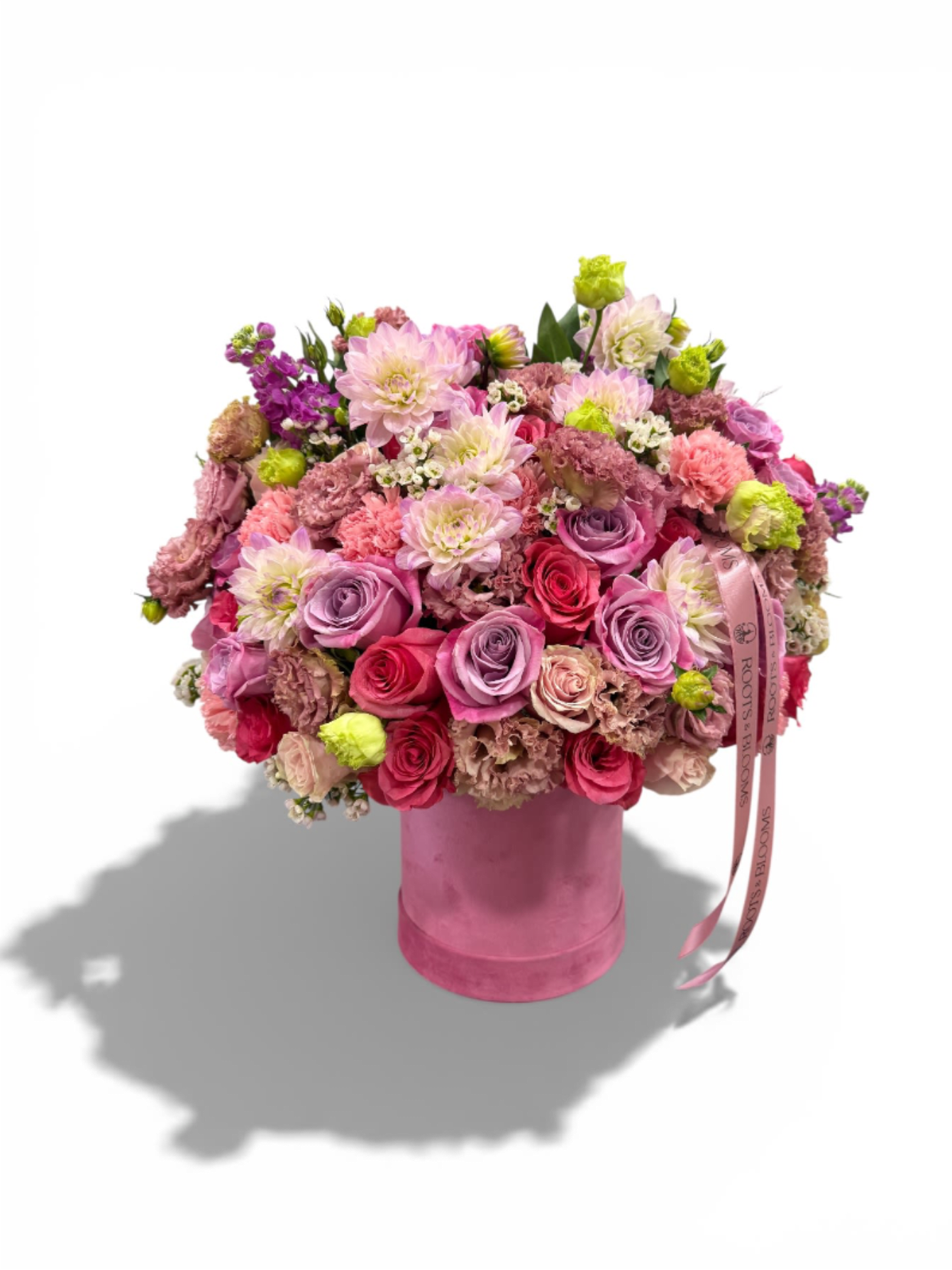 Pink Paradise - A vibrant garden style arrangement, bursting with pink roses, dahlias, lisianthus, carnations and seasonal blooms, beautifully designed in a chic pink hat box. A joyful and luxurious arrangement, perfect for birthdays, celebration, or simply brightening someone's day. 