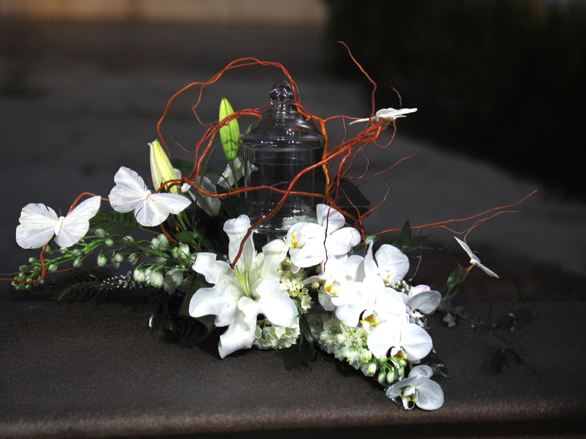 Tranquil Peace - Urn décor in all the classic all-whites-and-greens provides a sense of peace and tranquility.  Branch materials add a unique visual interest that hold white butterfly decorations.