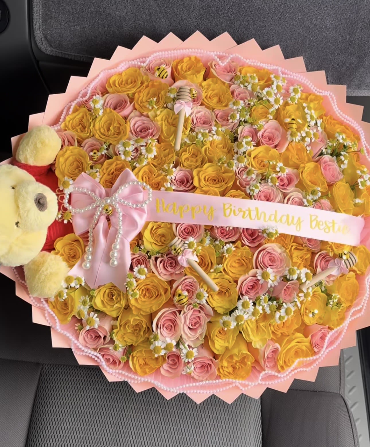 Phoo Birthday  - Celebrate someone special with this adorable and luxurious birthday rose bouquet, designed to make the moment unforgettable. This stunning arrangement features a beautiful mix of vibrant yellow roses and soft pink roses, symbolizing joy, friendship, and admiration. Delicate daisy accents add a fresh garden feel, while charming honeybee decorations bring a playful and unique touch.