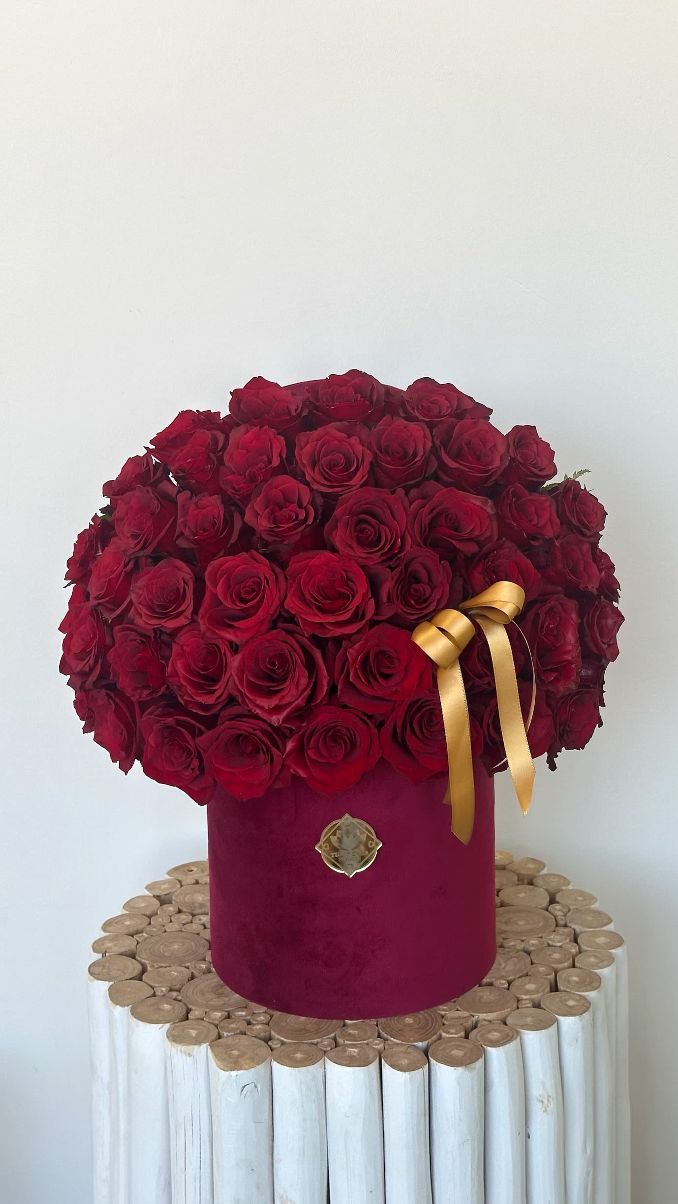 Classic Love Red Rose Box - A timeless arrangement of deep red roses in a luxurious velvet hat box, accented with a golden ribbon. The ultimate romantic gift for anniversaries, Valentine’s Day, or just to say “I love you.” Available for same-day delivery in Los Angeles and Sherman Oaks.  Available in two sizes – 55-60 roses, 80-85 roses, – this arrangement can be fully customized to match your vision. Choose from different rose colors (red, pink, white, yellow, or mixed) and different box colors (white, black, or custom shades).  Included: Elegant round hat box, designer ribbon, and complimentary flower care.