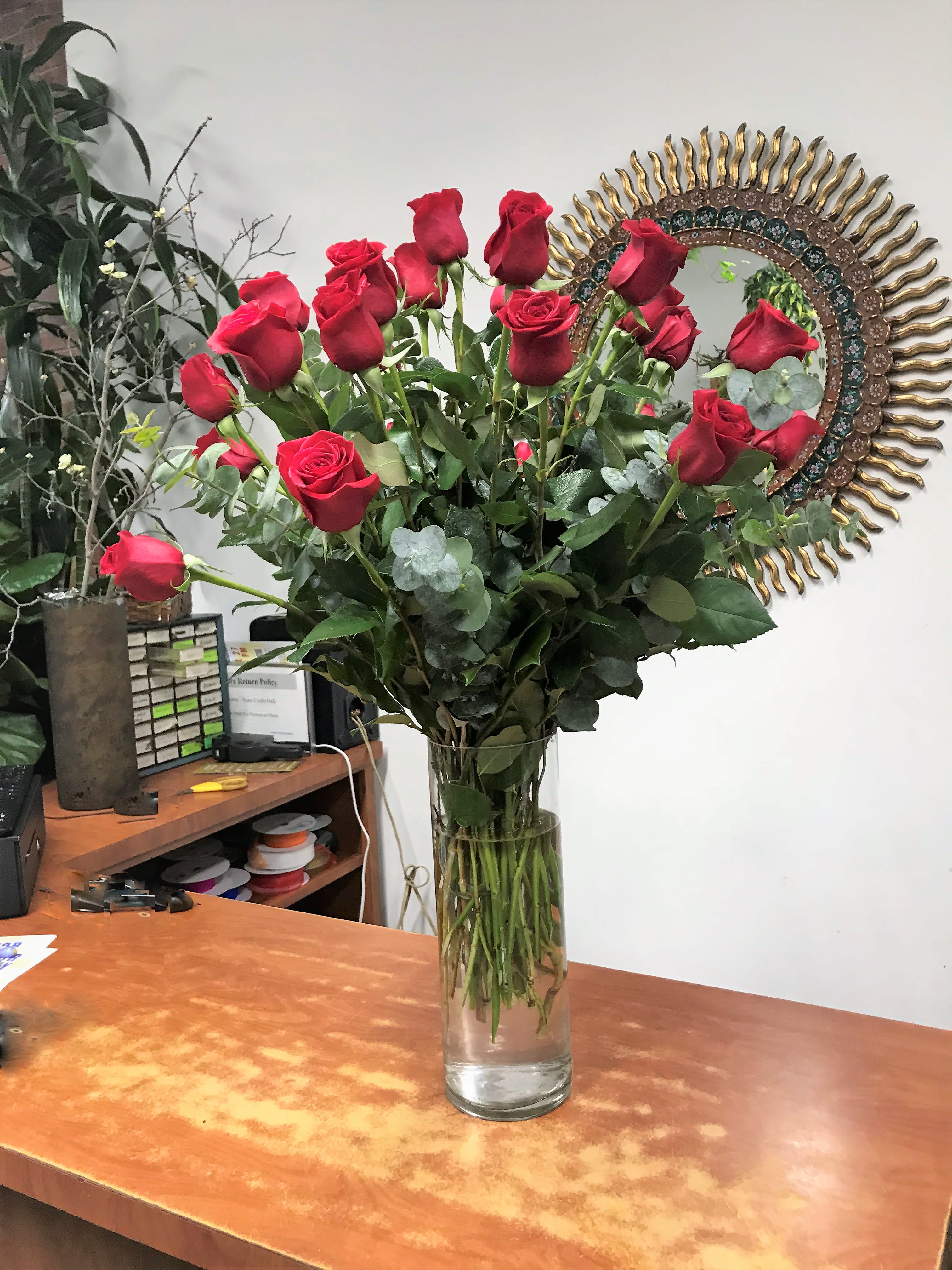 Romantic Reds  - Simplicity and elegance! A beautiful creation of James Weir's designers' team. Two dozen long stem red roses are arranged in a clear glass vase. 