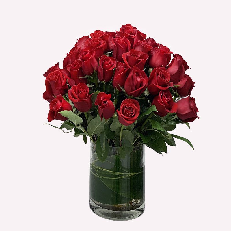 The Montague - This arrangement is one of our classics. Red roses are artfully arranged in a glass vase with tropical green leaf to add effect.  NOTE: Due to Valentine's Day, prices and availability of this product may be affected.