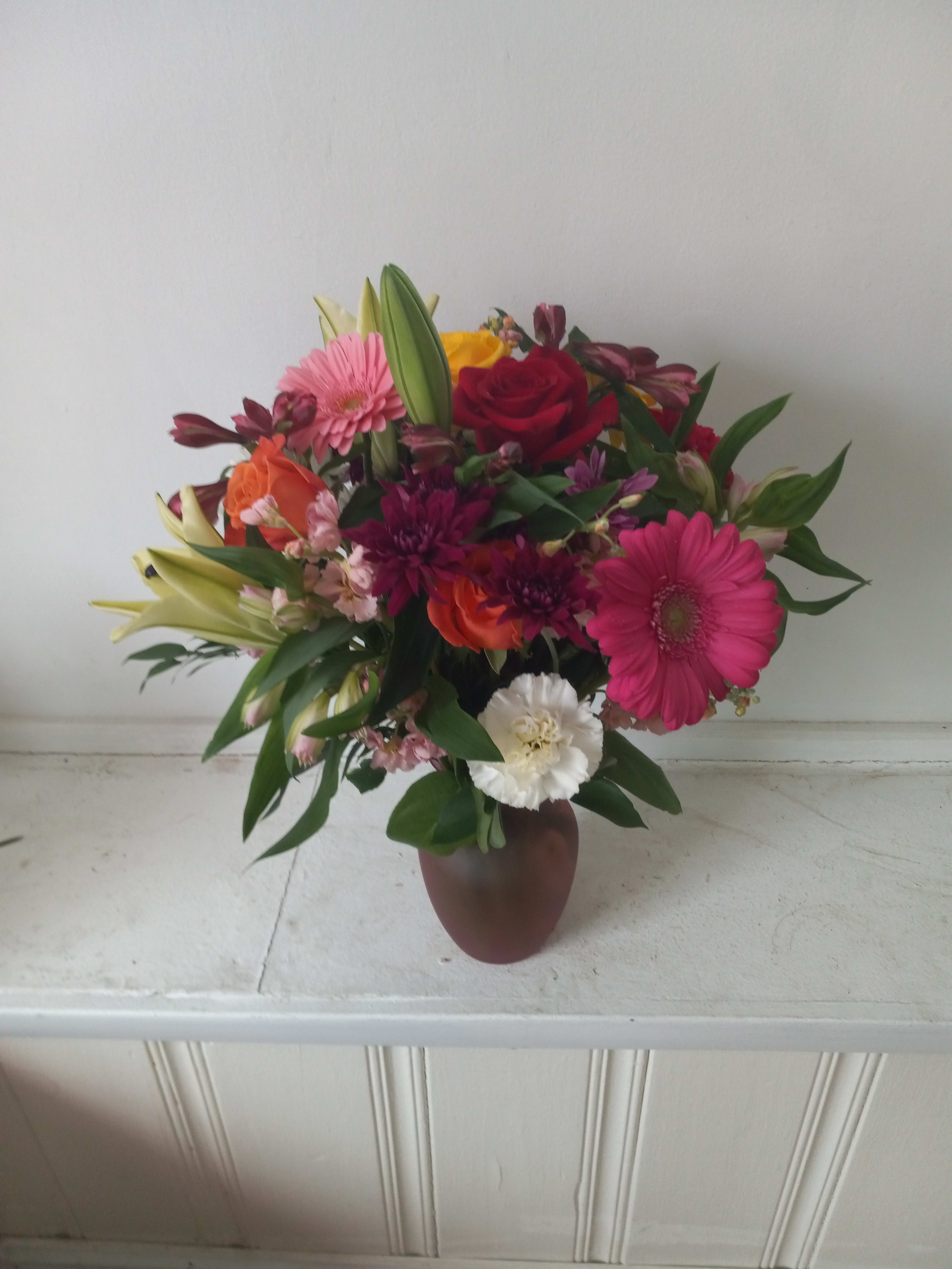 "Heidi"  - Beautiful fresh deep bright burgundy daisies, various roses and sparkly pink and yellow gerbera daisies with pink Alstroemeria in a vase  