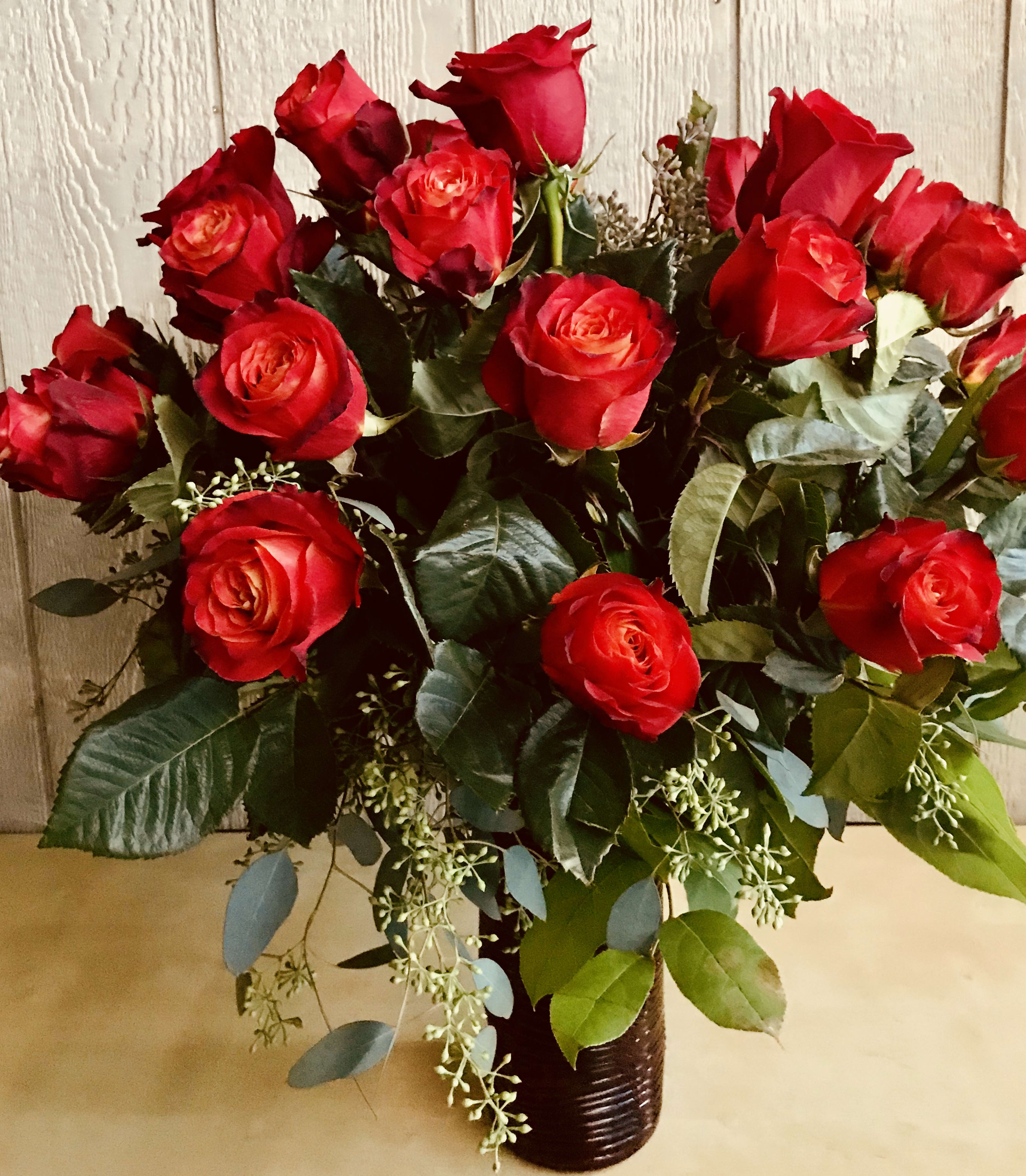Steel Magnolias - 2 Dozen hot orange roses in a glass vase with a nice greenery