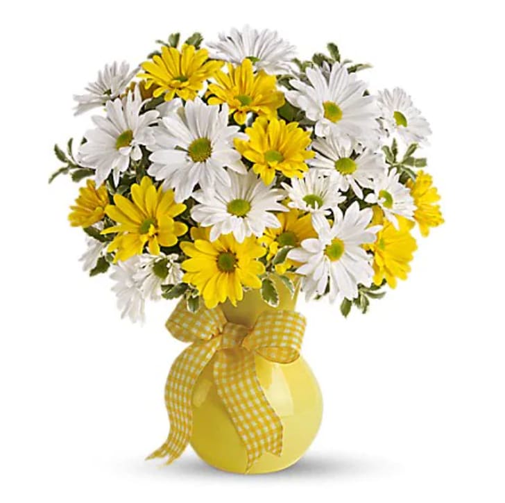 Upsy Daisy - What could be sweeter than a cheerful yellow vase filled with white and yellow daisies? Can't think of anything? Then choose this sunny bouquet. It will brighten their day. The bright bouquet includes white daisy spray chrysanthemums, yellow daisy spray chrysanthemums and bupleurum accented with fresh greenery.Delivered in a bright yellow vase.   Orientation : One-Sided  All prices in USD ($) 