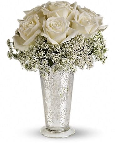 White Lace Centerpiece - Queen Anne's lace forms a delicate collar around radiant white roses inside an antiqued Mercury Glass Vase. Looks lovely next to the wedding guest book, on smaller cocktail tables, or on your beloved wife's boudoir. White roses and Queen Anne's lace are the simple but gorgeous ingredients in this centerpiece, presented in an Mercury Glass Antique Vase. 