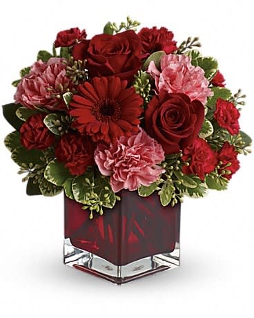 Together Forever - Hoping to be together forever? Whether you'd like to send a message of love to a favorite beau, best friend or family member, this charming, crimson-hued bouquet - delivered in a special red glass cube vase - will be a lovely sentiment of your affection. A mix of roses, carnations and more in shades of red and pink accented with greenery.  