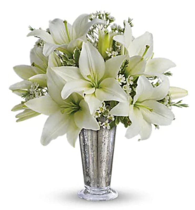 Written In The Stars - This classic silver and white arrangement is a stunning way to let that special someone know how you feel. Inspired by a romantic night sky, it's a dazzling way to pay homage to your years together.  Elegant white lilies and pretty white waxflower stems are exquisitely arranged in a silver Mercury Glass Antique vase that's reminiscent of a star-filled sky. It really is a wish come true.  Orientation : All-Around  All prices in USD ($) 