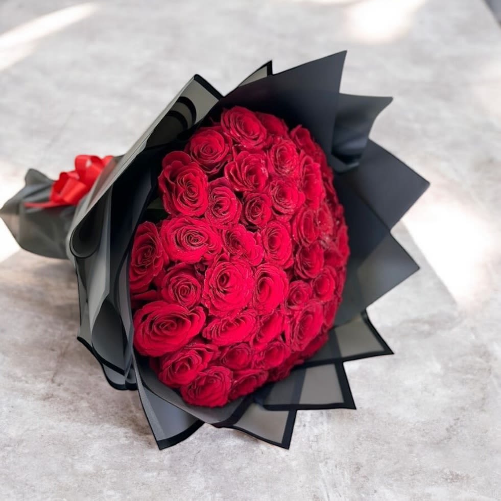 25 Red Roses Bouquet - This bouquet is designed with Korean inspired floral artistry with premium wrapping paper. It is the best way to present a bouquet of roses to surprise that special someone!Please note, this arrangement does not include a vase to hold roses. 
