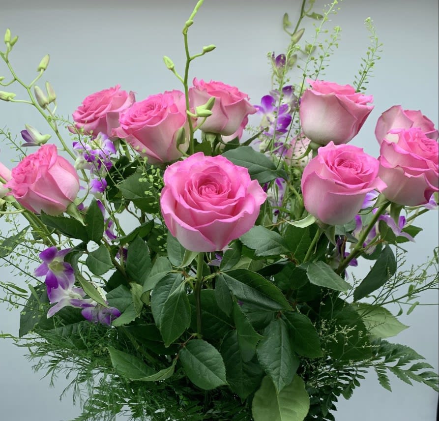 PINK PERFECTION $150/200/250 - Our Pink Sweet Unique Roses are bright and beautiful long stem premium roses with lavender dendrobium orchids added for a special touch.  Shown as one dozen, Deluxe eighteen and Premium two dozen.  Finishing touches include fragrant candles, Teddy Bear Plush, Chocolates and even our Vintage Brooch collection.