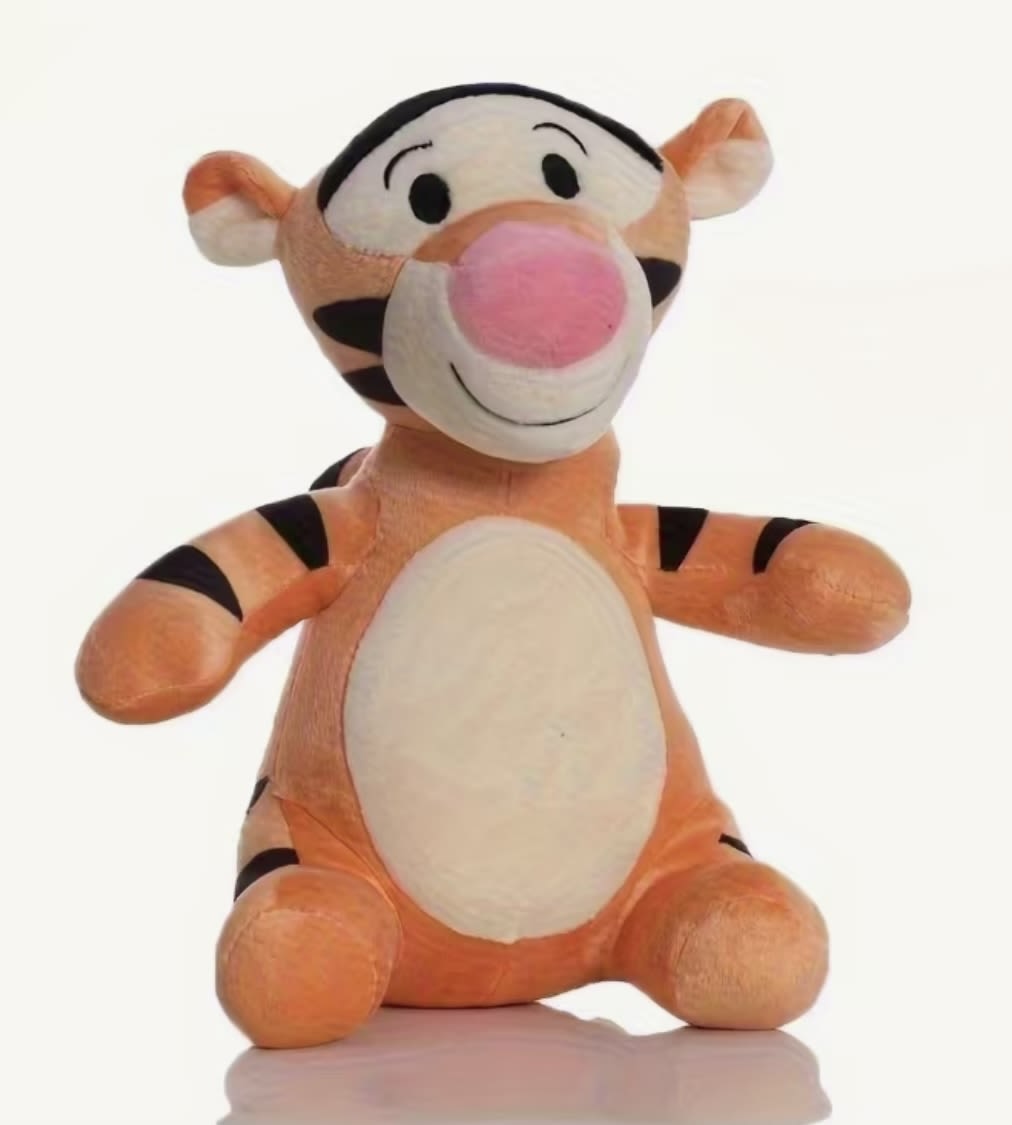Plush Tigger stuffed animal sitting upright on a white background